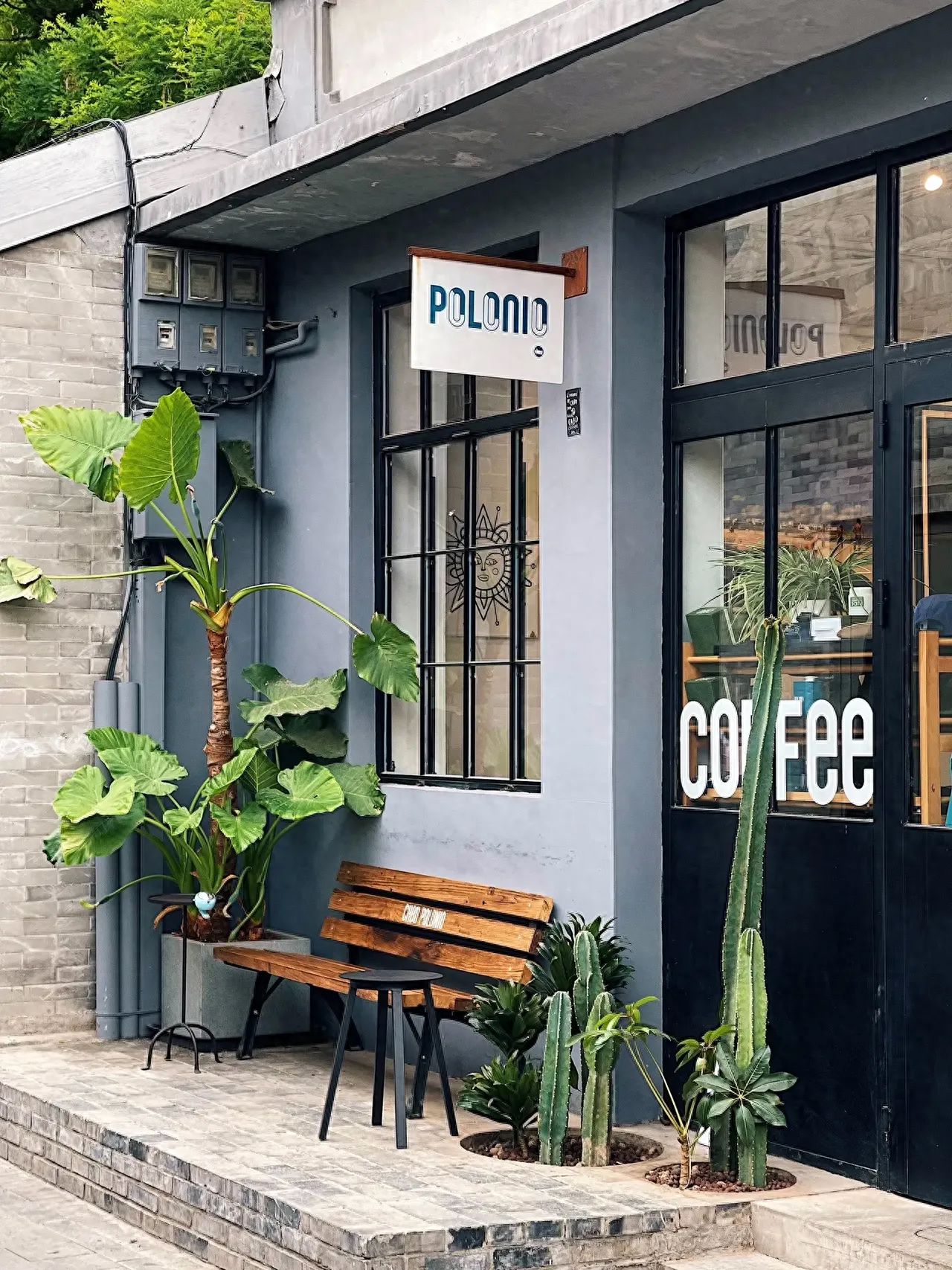 Photo by Polonio Coffee - Signage Pictured with Bench and Greenery