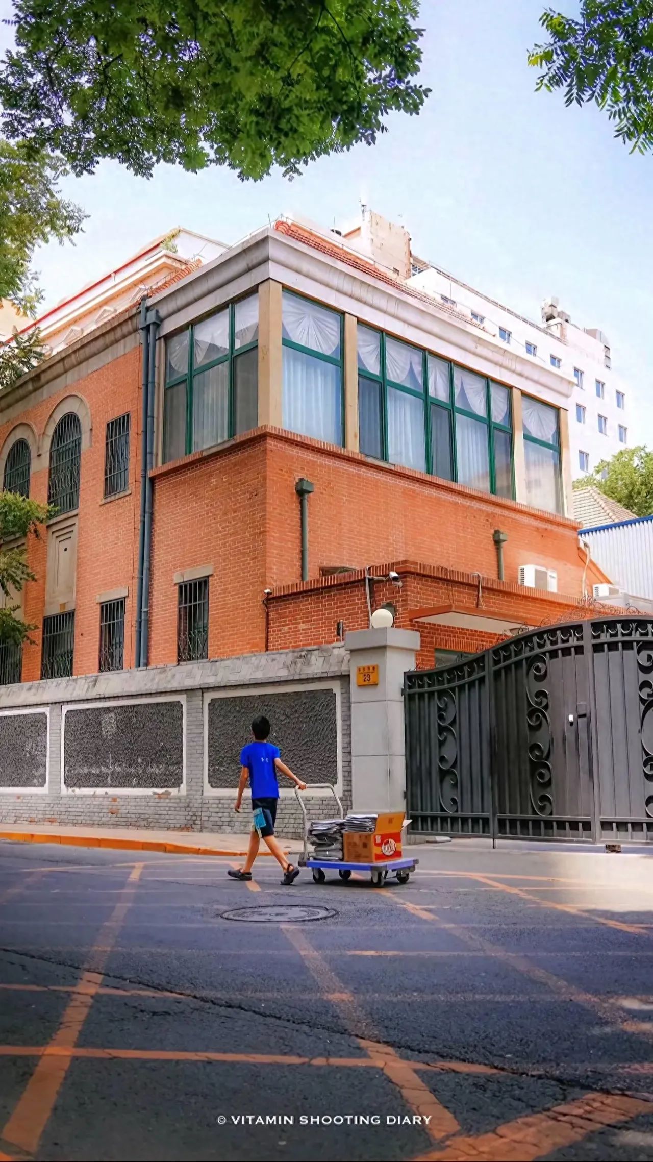 The photographer stands across the street, capturing the scene from a low angle looking up, enhancing the towering sense of the building and the dynamic effect of the characters. Place the orange-red brick building and the characters in the center of the frame to highlight the visual focus of the subject.

1. Dressing Suggestions: It is recommended to wear light-colored cheongsams or French-style dresses, paired with straw bags. Due to the long cobblestone road, it is essential to wear flat shoes.

2. Travel Tips: The best photography time is suggested to be from 7:00 to 10:00 in the morning or from 16:00 to 19:00 in the evening. It is advised to avoid shooting between 12:00 noon and 15:00, as some parts of the road may lack shade.

3. Other Experiences: It is recommended to stroll or cycle here on a sunny day for a pleasant experience. During the visit, pay attention to the historical plaques on the walls. You can scan the QR codes to learn about the past and present of the buildings. When the streetlights come on, the bas-reliefs of the buildings will have a more film-like feel under the warm light.