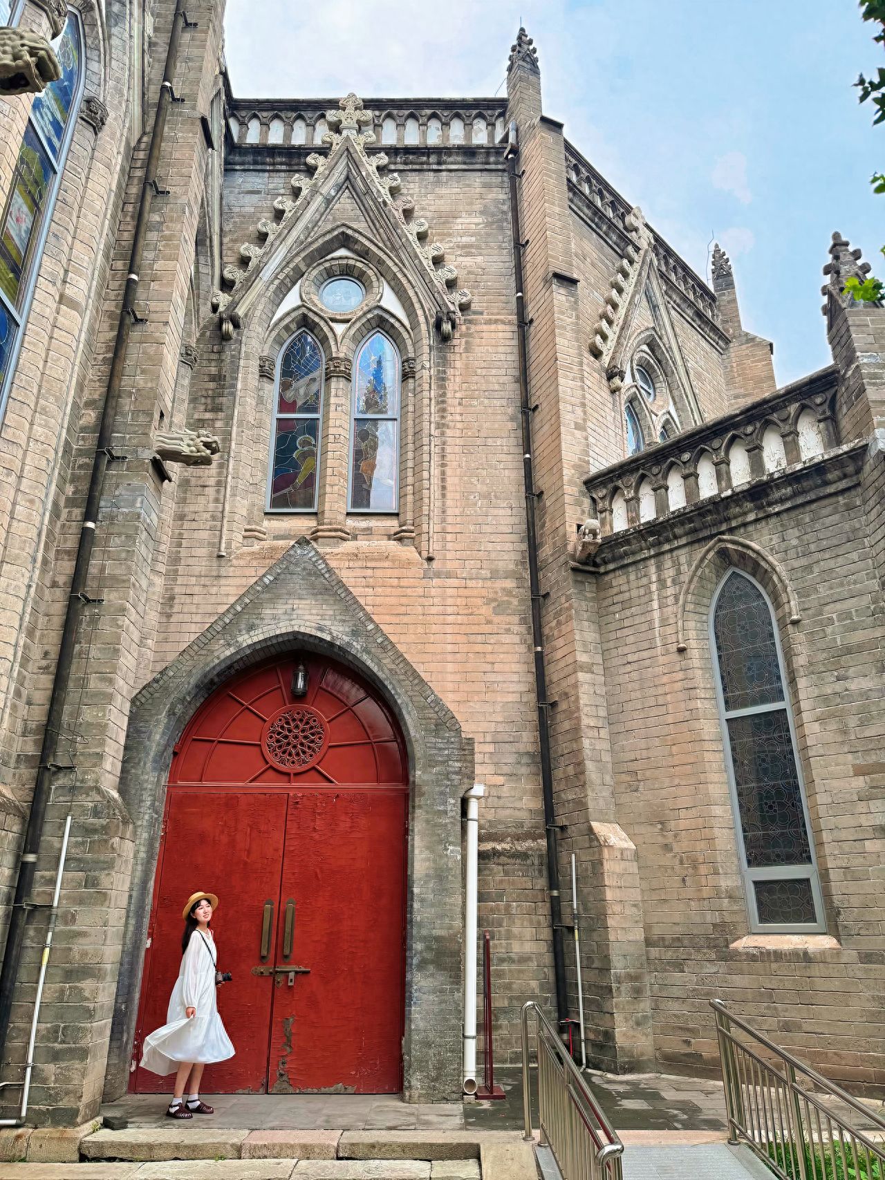 Photo by The Cathedral of the Immaculate Conception, XiShiKu - brick walls and red doors
