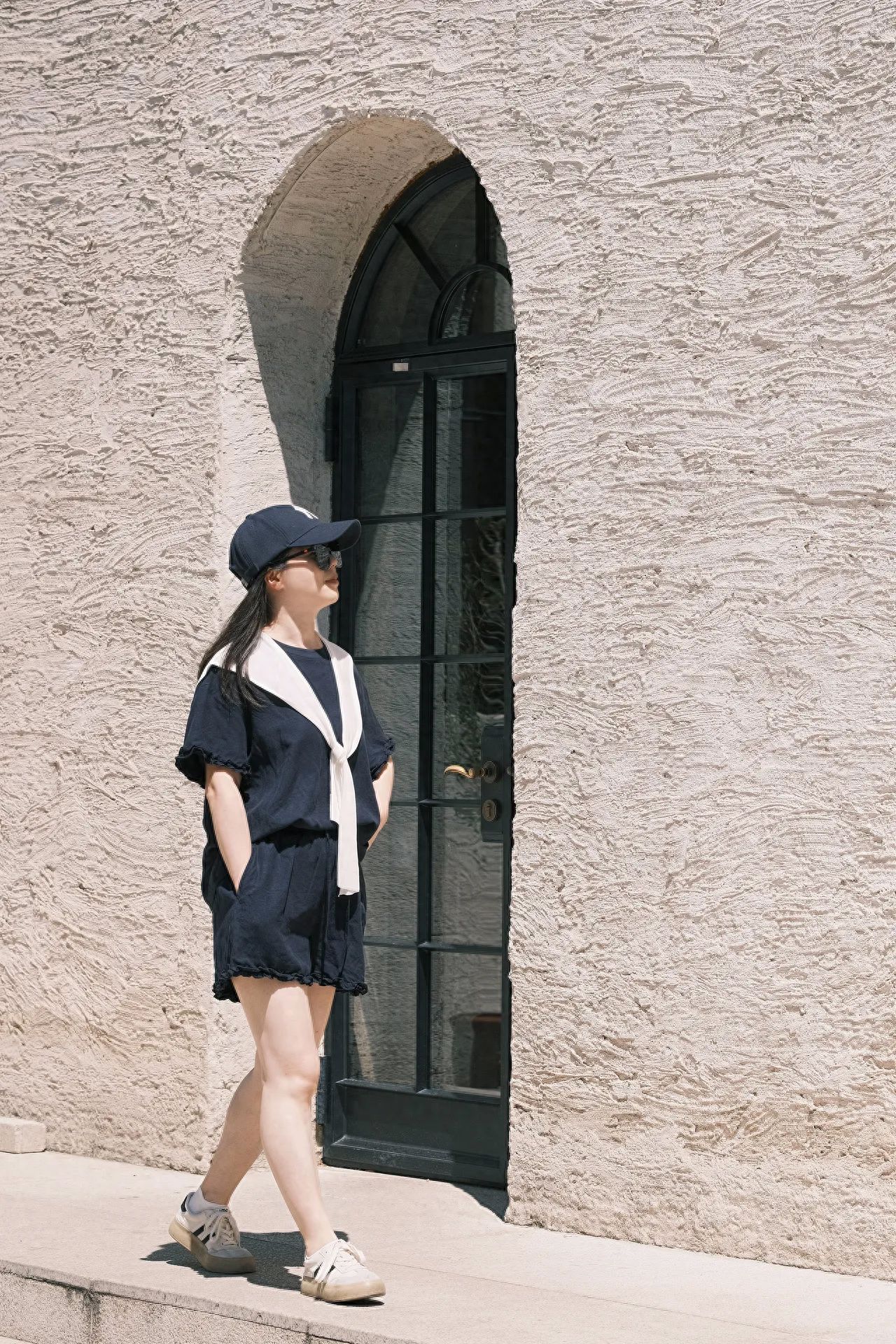 Photo by Chinese National Academy of Painting - Take a photo with beige textured walls and arched glass doors.