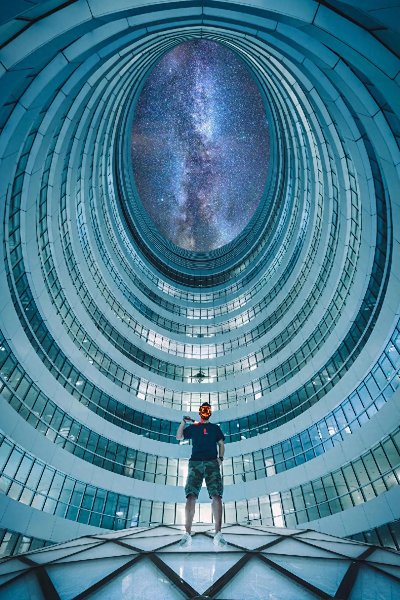 The photographer employs a centered composition, placing the circular structure of the building perfectly in the middle of the frame, creating a symmetrical effect that enhances the visual impact. Standing directly in front of the model, the photographer uses a low-angle shot to focus on the building and its galactic effect at the top, capturing the entire atrium structure within the frame. It is recommended to use an ultra-wide-angle lens or a 0.5x smartphone lens to ensure an exaggerated sense of space and depth in the image.
