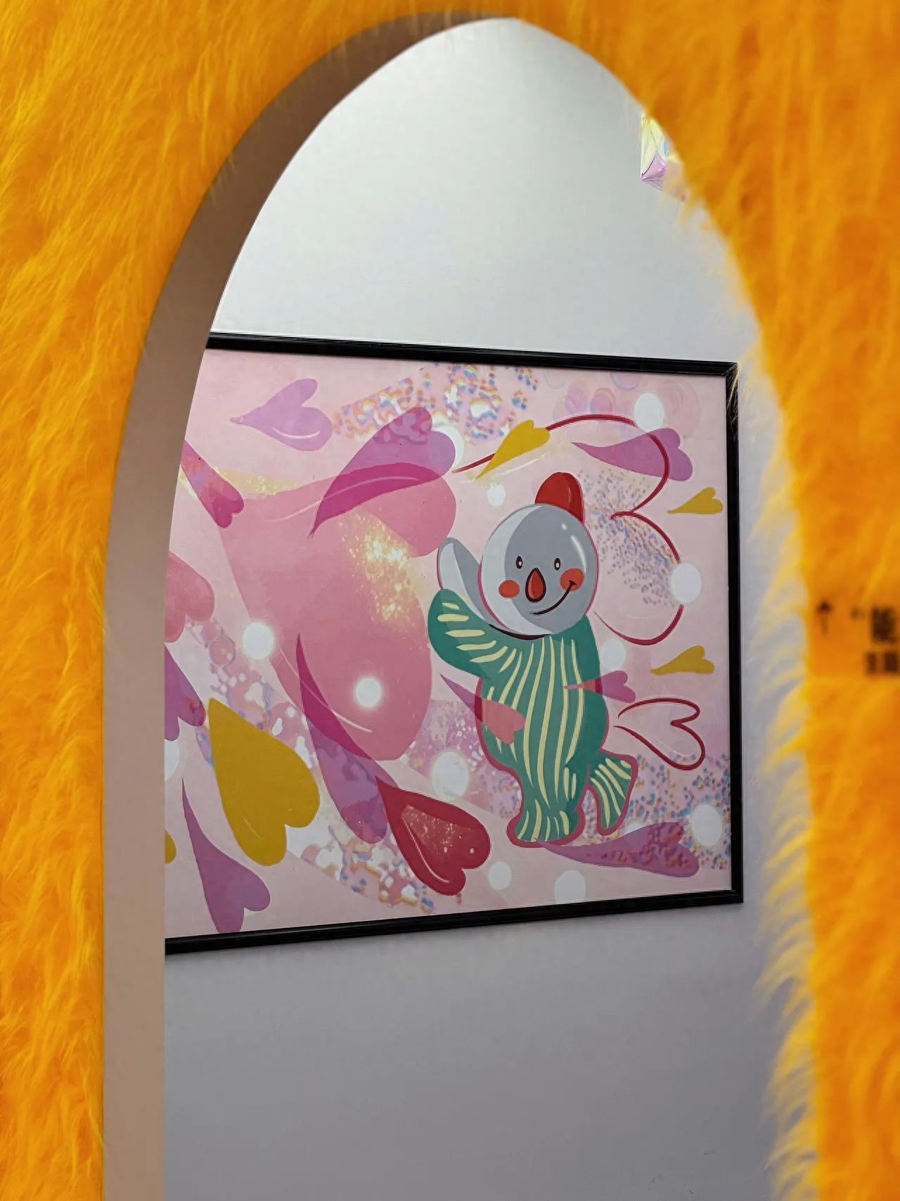 Photo by Beijing Baobao is here - Pink snowman painting behind the archway.
