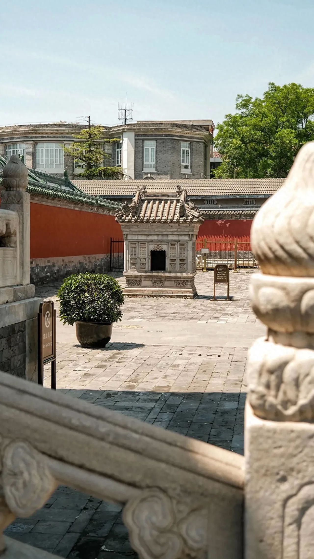 Photo by Emperors' Temple - Take a photo of the burning paper incense burner near the stone railing.