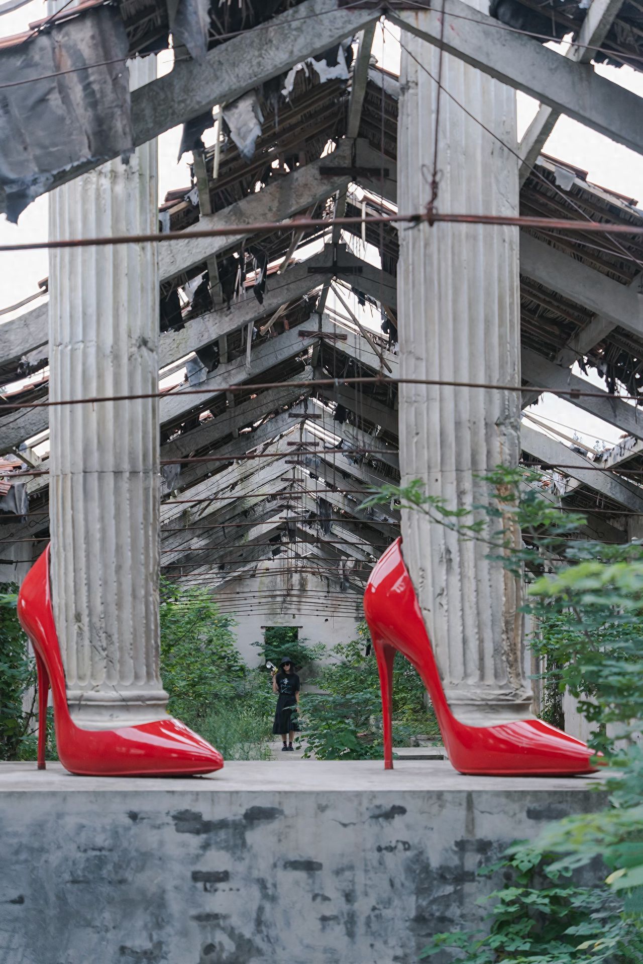 Position yourself in front and to the side of the red high heels, capturing the image at eye level with a symmetrical composition that showcases both the heels and the Roman columns. Use a telephoto lens with a small aperture to ensure clarity throughout the frame, creating an absurd yet artistic atmosphere. 

Admission Price: Free, but reservations must be made in advance through official WeChat public accounts and other channels.