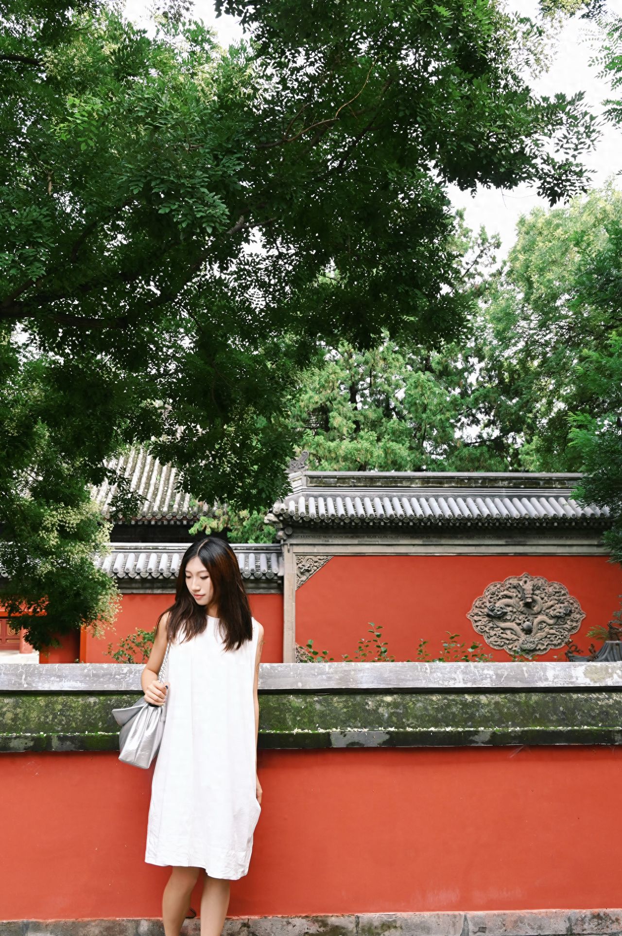 Photo by Fragrant Hills Park - The red walls and brick tiles of Biyun Temple amidst large trees.