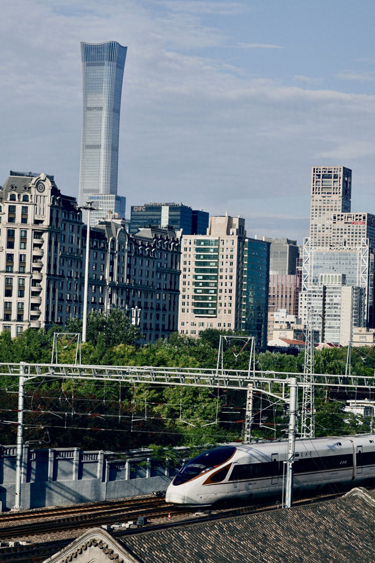 Photo by Beijing Ming City Wall Relics Park - Zhongxin Building and Train in the Same Frame