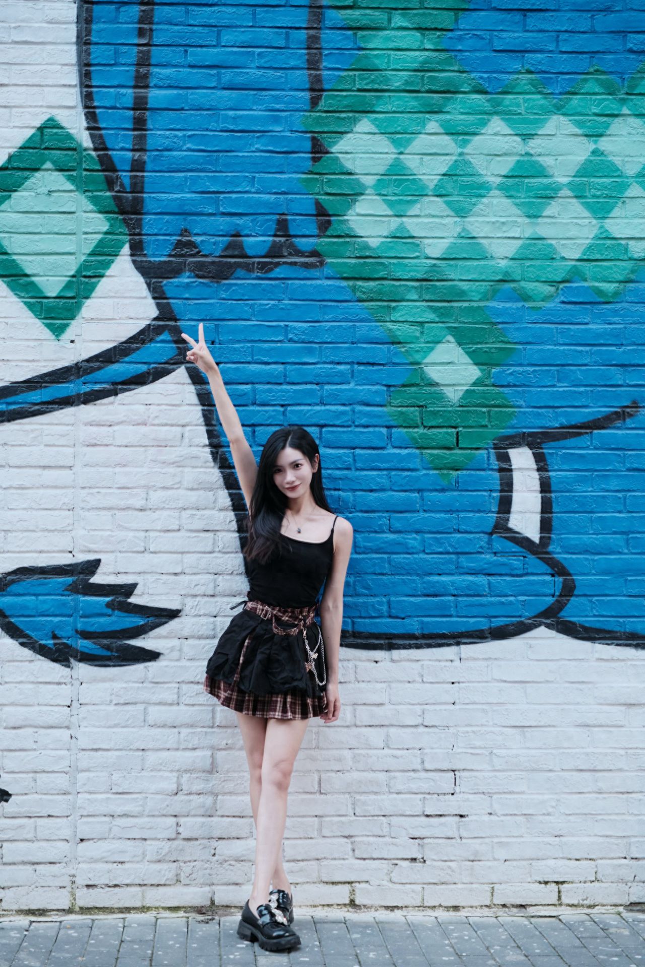 Photo by Moon River Art Town - in front of the blue cartoon character mural wall