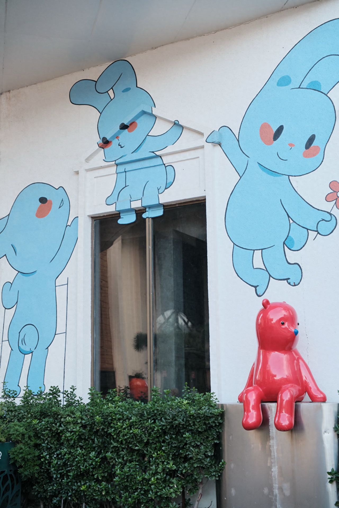 Photo by Moon River Art Town - Rabbit Wall Mural and Red Sculpture