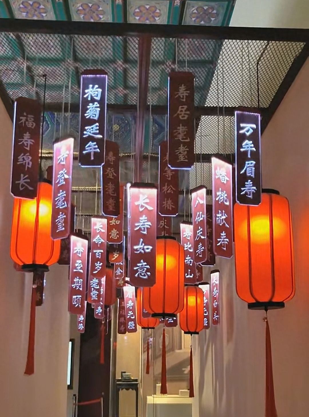 Photo by Beijing Wanshou Temple - Interior corridor with lanterns and blessings decorations captured.
