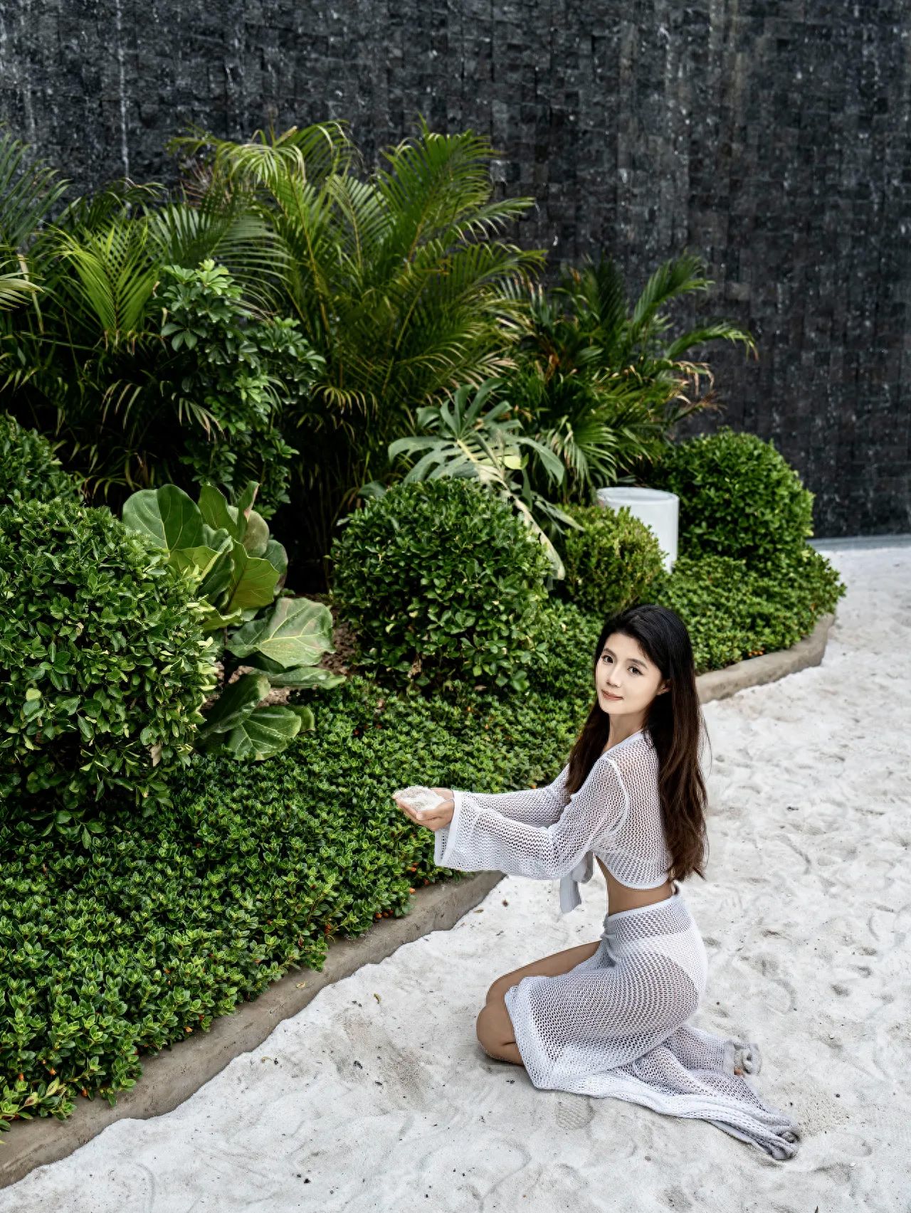 Photo by Huashan Garden - Taking a Photo with White Sand and Green Plants