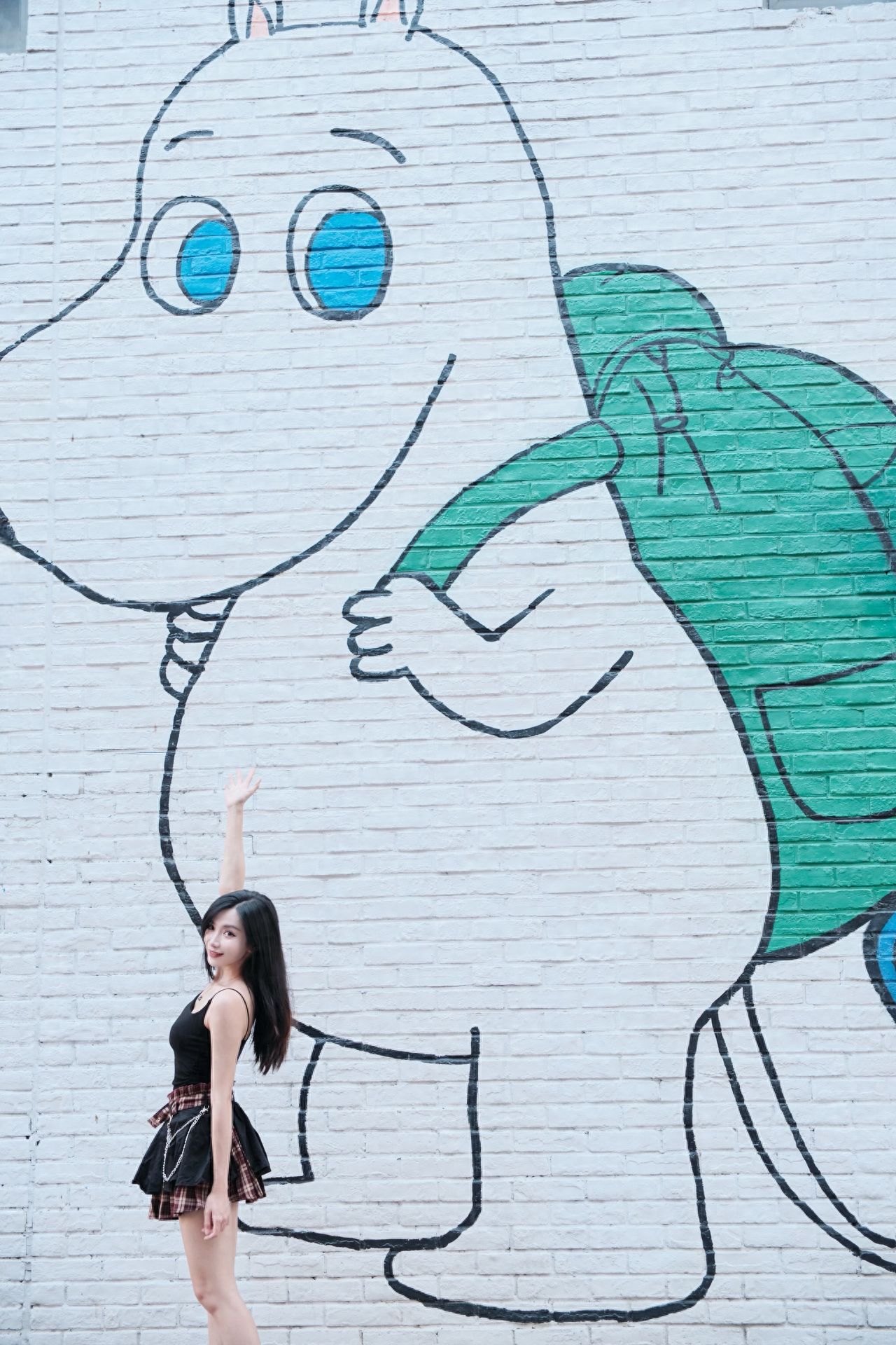 Photo by Moon River Art Town - Green Backpack Hippo Mural