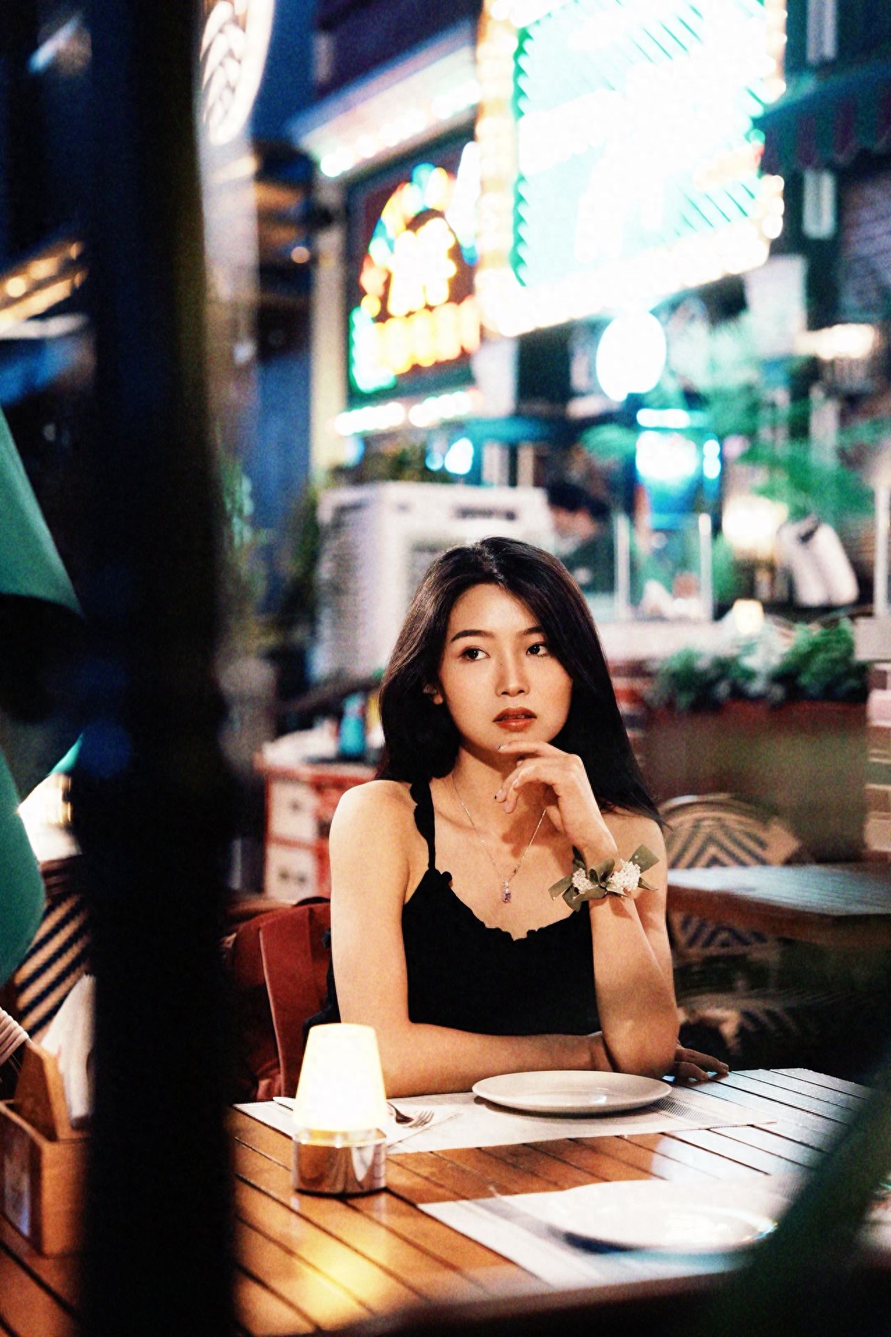 Photo by Beijing Blue Harbor - Take a photo with wooden tables and lighted buildings