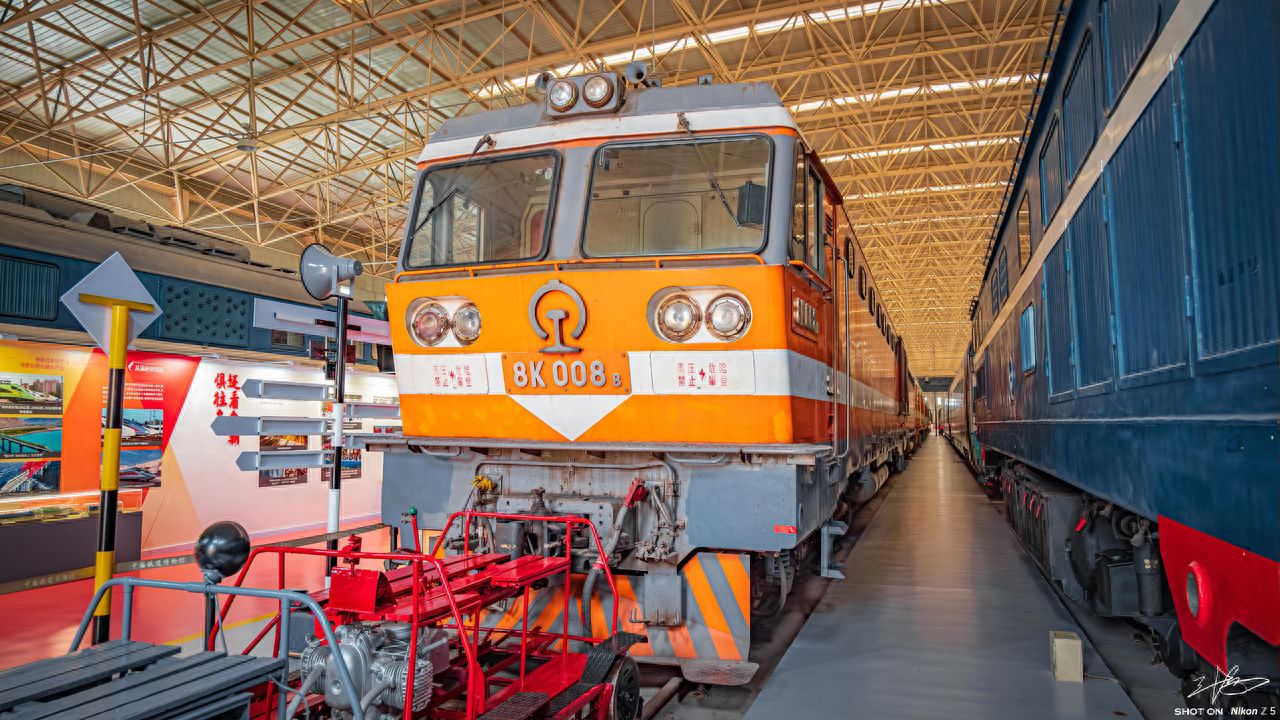 Photo by China Railway Museum - Orange Locomotive and Blue Carriages