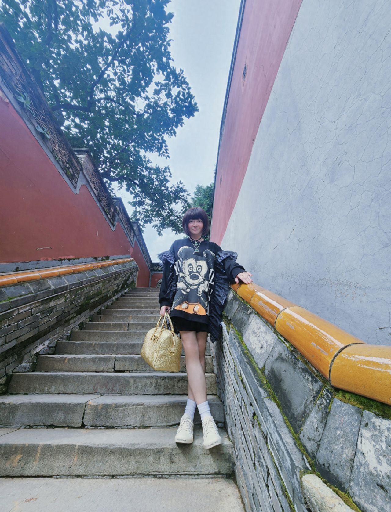 Photo by Tanzhe Temple - Taking a photo on the steps with the red walls