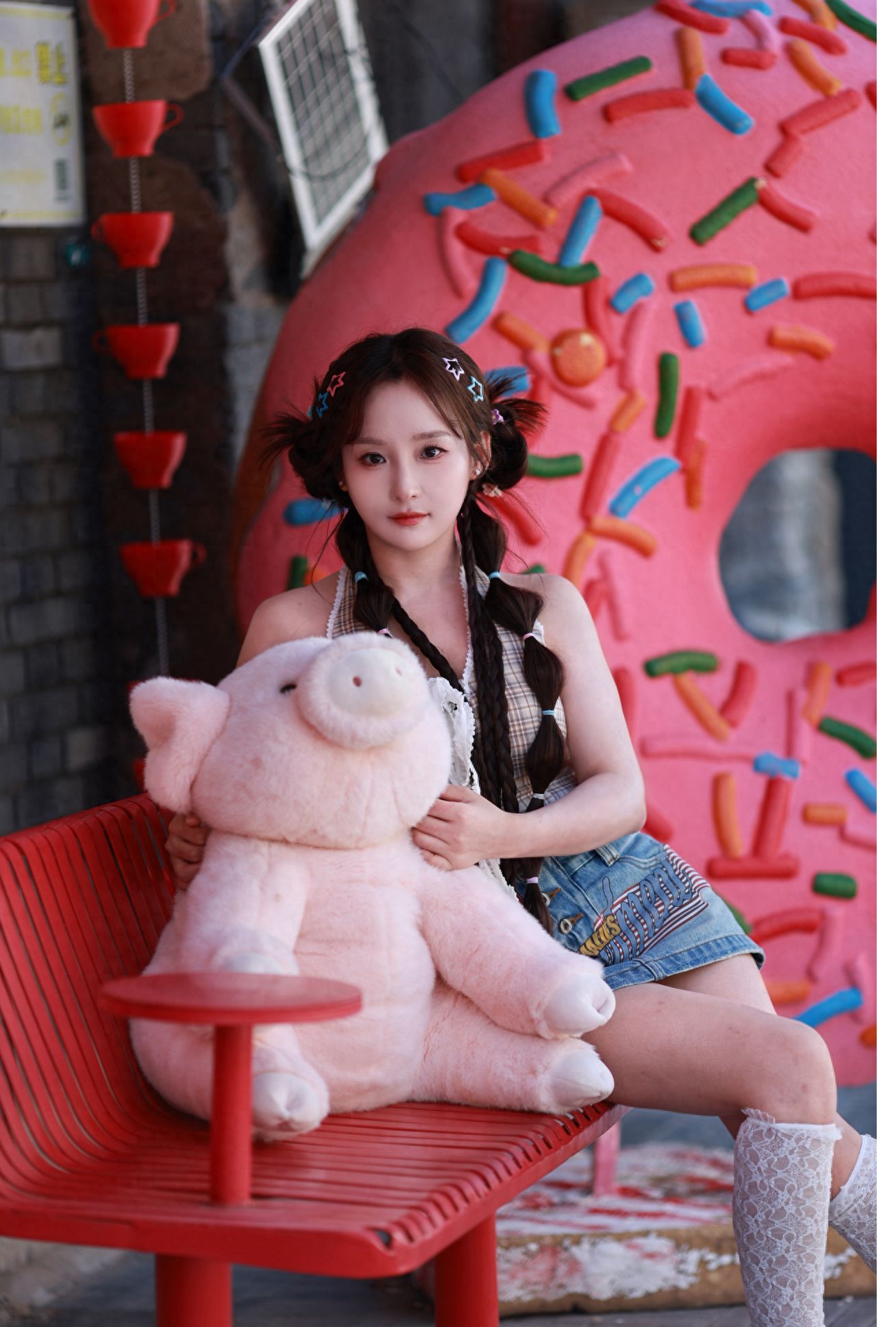 Photo by Romantic Hutong - Take a photo with the red benches and the large doughnut installation.