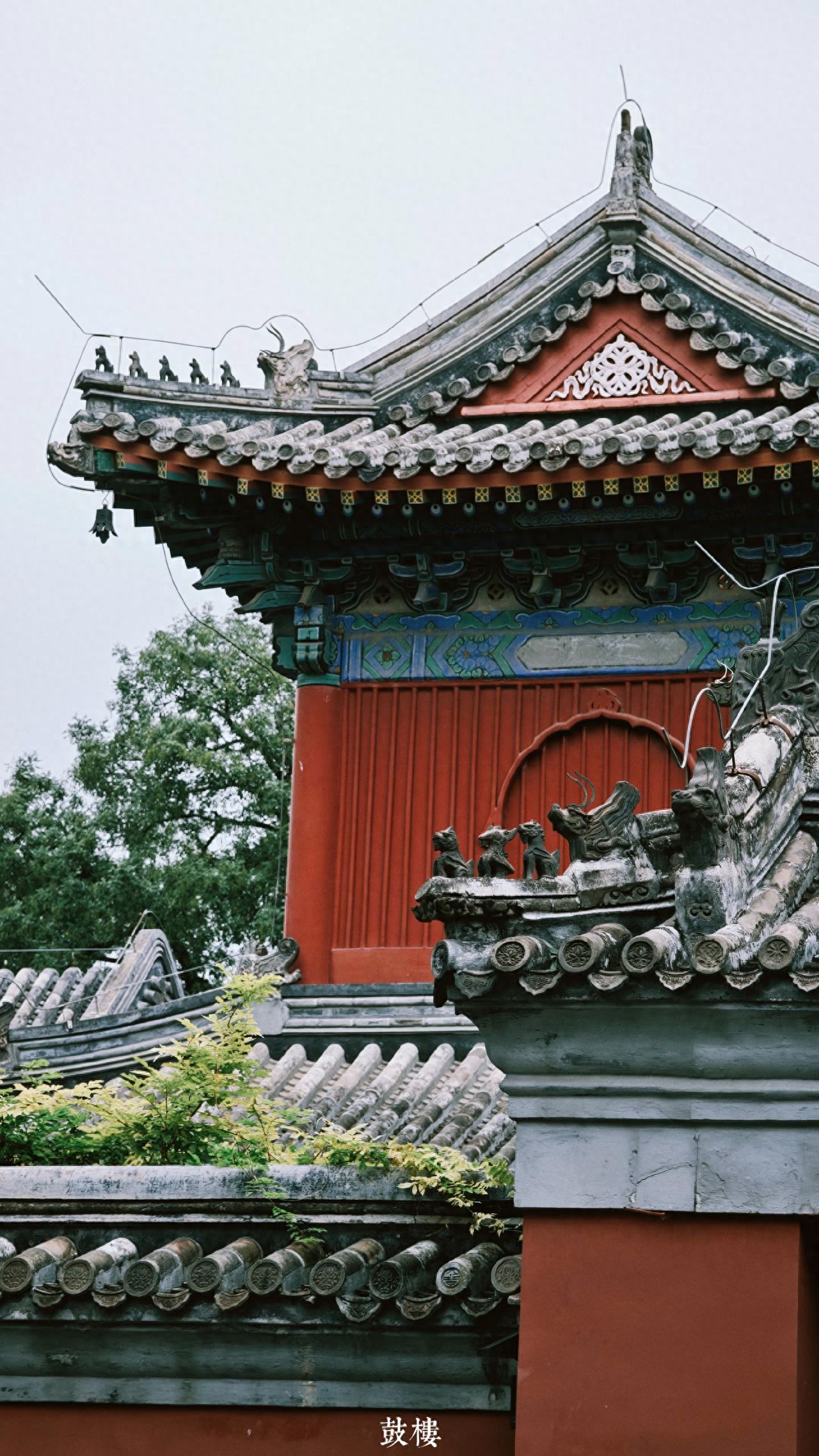 Photo by Wanshou Temple - Drum Tower Roof Ridge Beast Tiles and Red Walls in Beijing