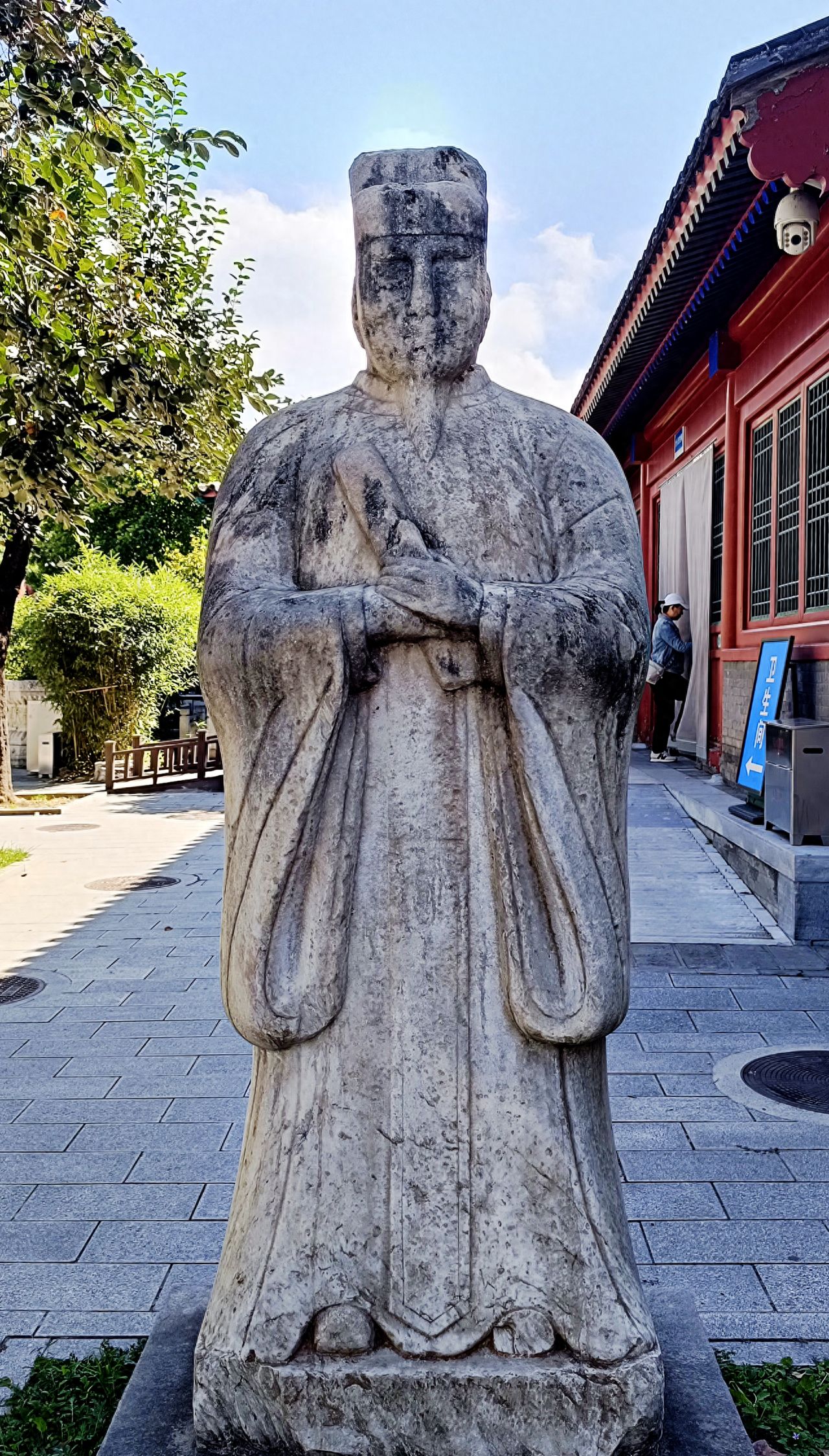 Photo by Beijing Stone Carving Art Museum - Photographing stone carving figures and blue signs