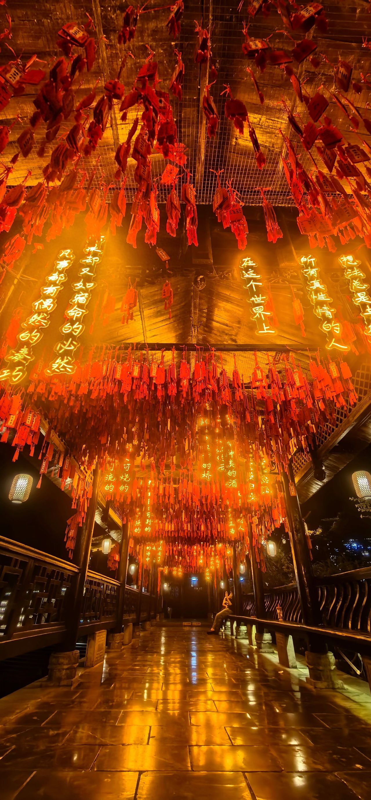 Photo by The night view of the red prayer plaques and lanterns in the Bi Cheng Cha Dong Scenic Area corridor.