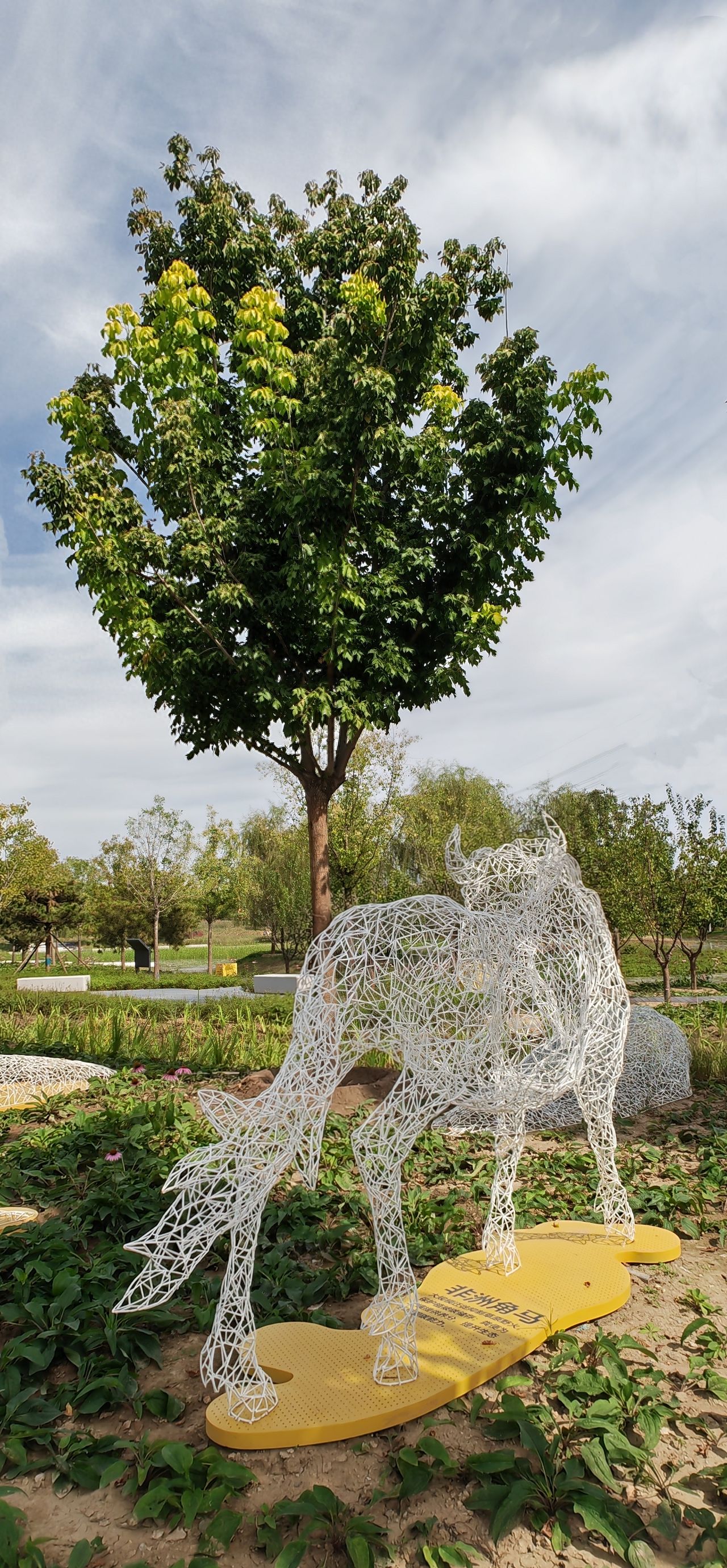 Photo by Wenyu River Park - White Metal Wire Antelope Sculpture and Trees