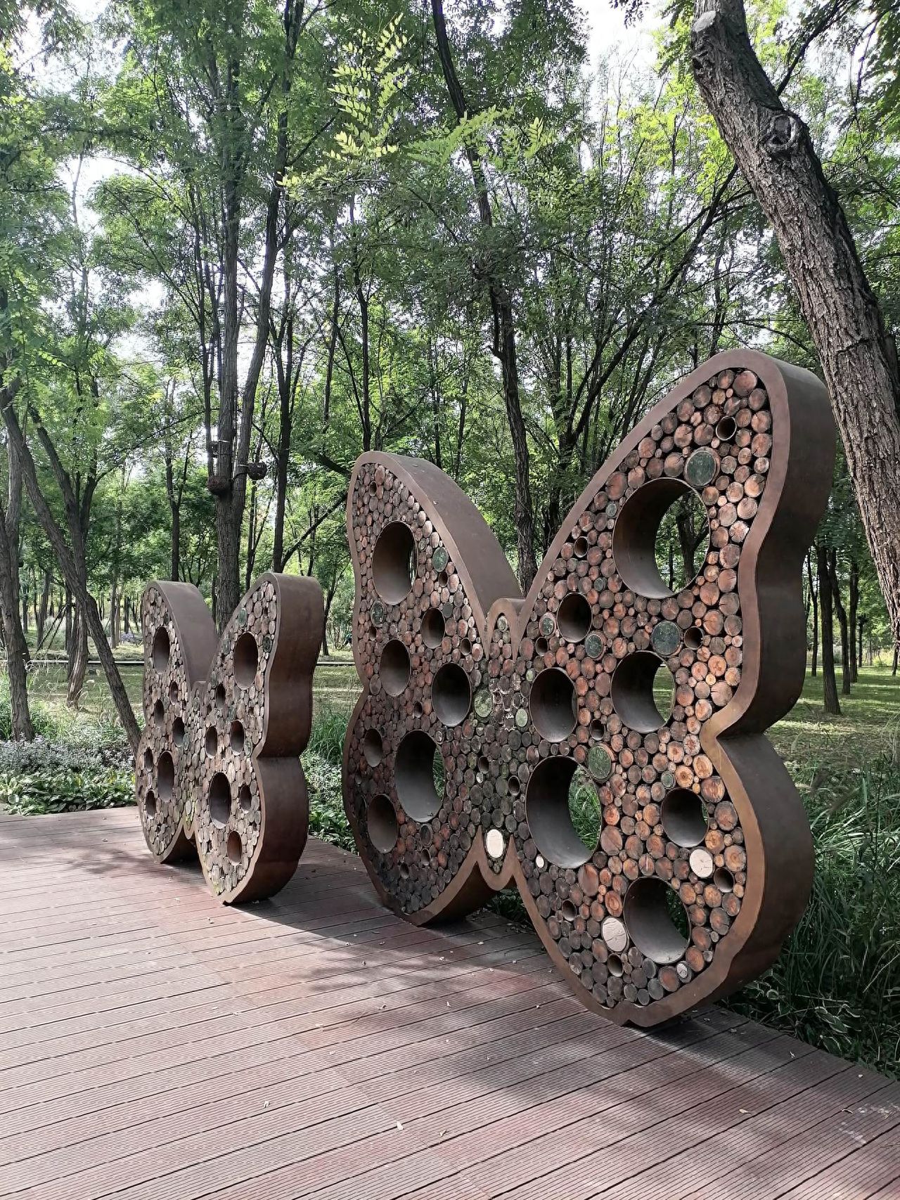 Photo by Beijing Wenyu River Park - Hollow-out Butterfly Art Installation on the Wooden Walkway