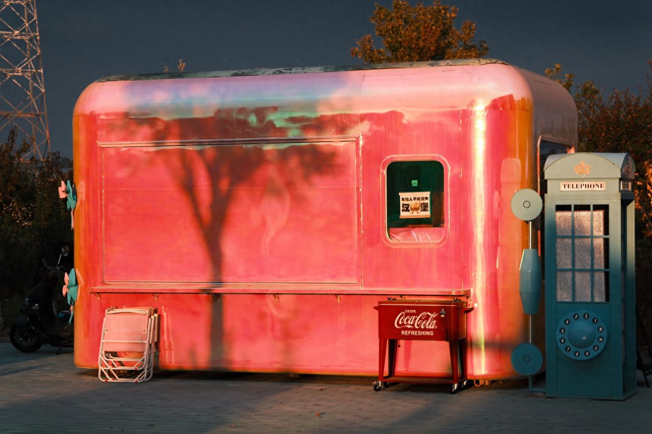 Photo by 491 Space - Pink Retro Building and Blue Telephone Booth