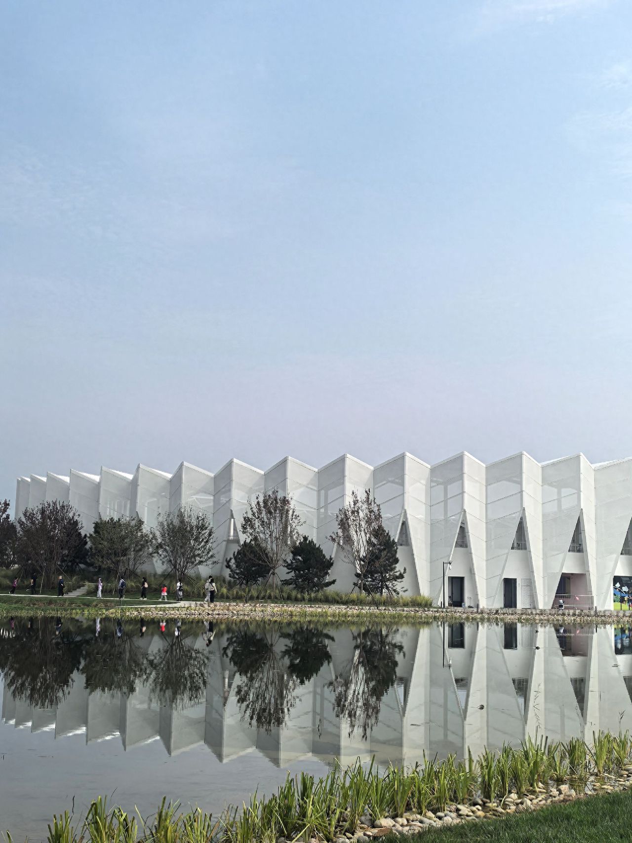 Photo by Wenyu River Park - Capturing Modern Architecture and Water Reflections