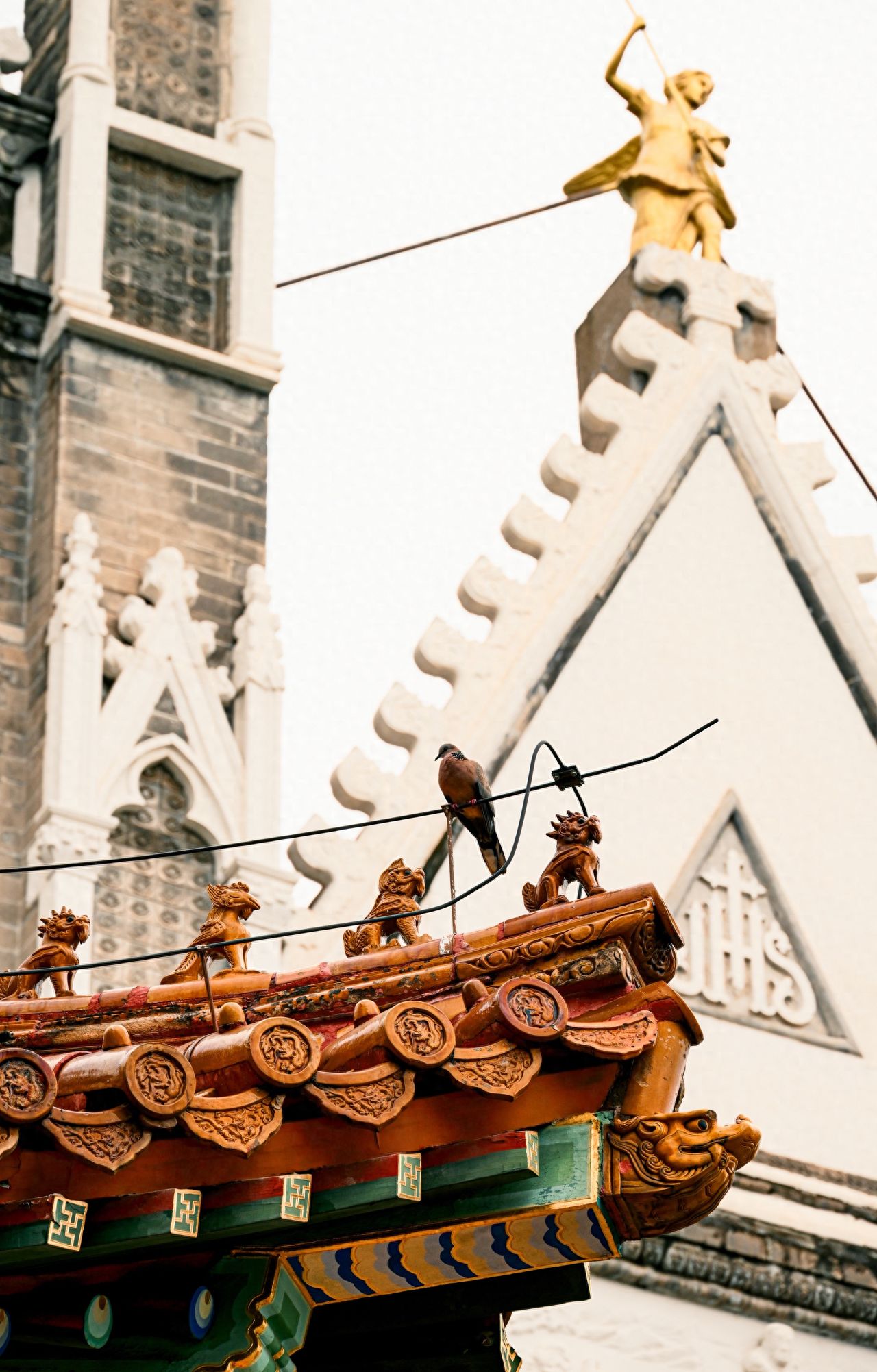 Photo by Xishiku Catholic Church - Eave Sculptures and Triangular Building Gold Statues
