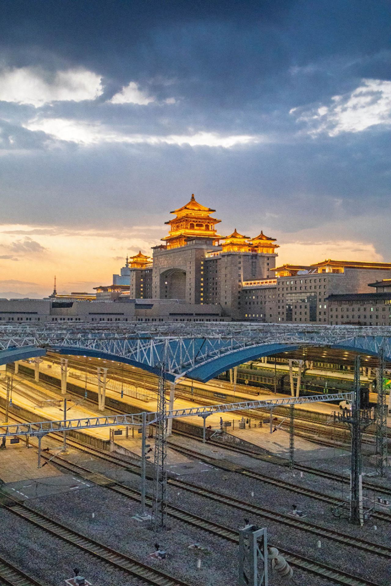 Photo by Beijing West Railway Station - Nighttime photography of train tracks and the architecture of Beijing West Railway Station.