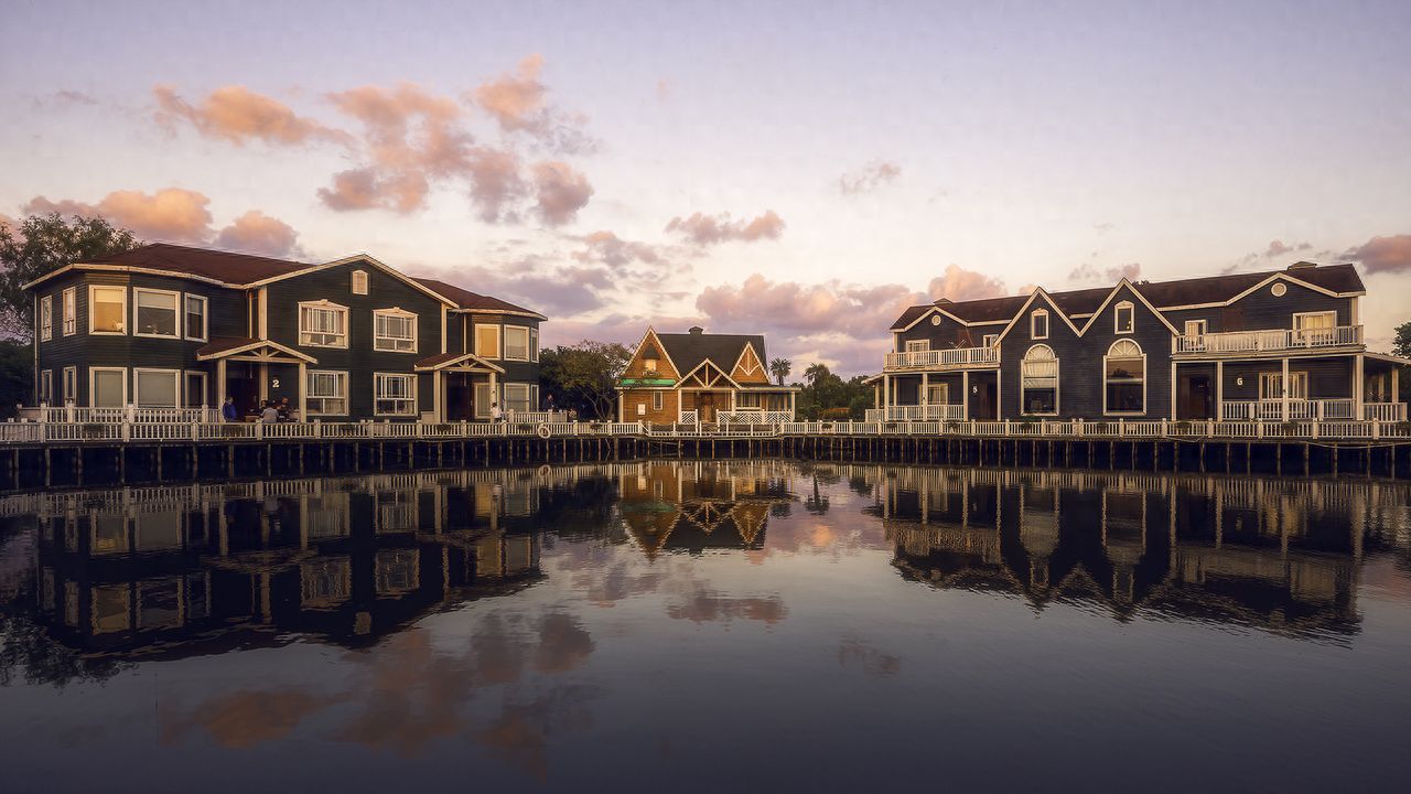 Photo by Senmiao Waterside Wooden Villa Estate – Reflections of Buildings at Dawn and Dusk
