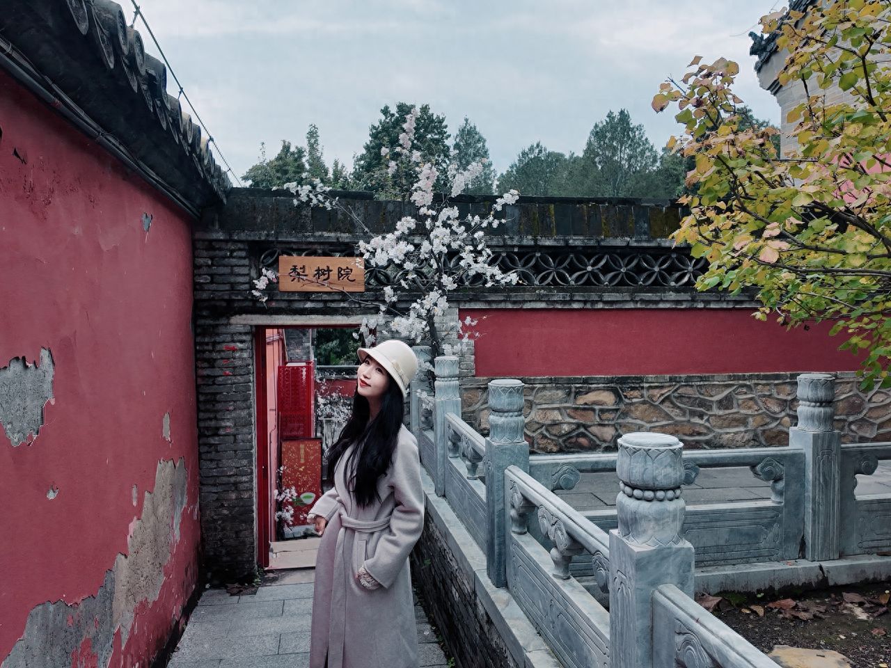 Photo by Tanzhe Temple - Take a photo with the red walls, stone railings, and flowering trees at the Pear Tree Courtyard.