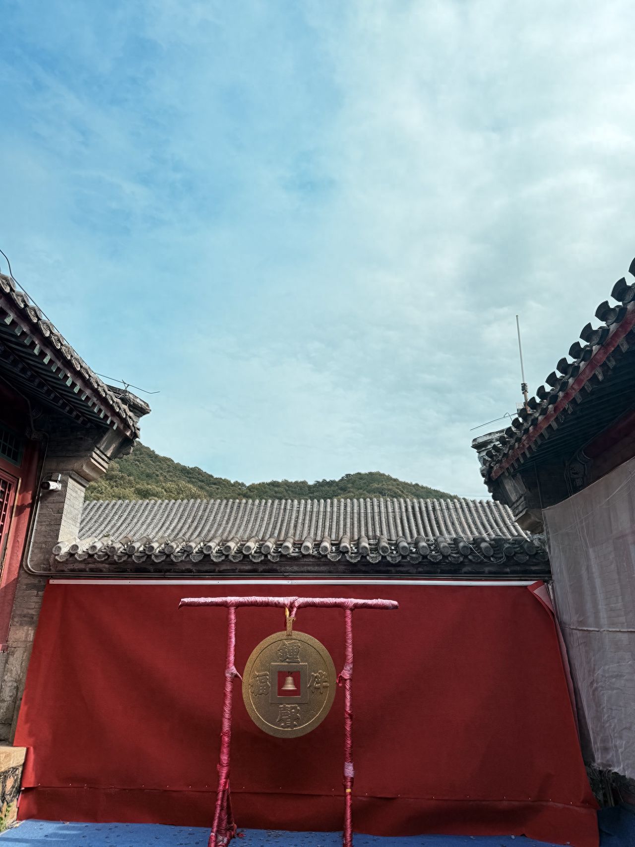 Photo by Tanzhe Temple - Copper Coin Installation and Red Wall Eaves