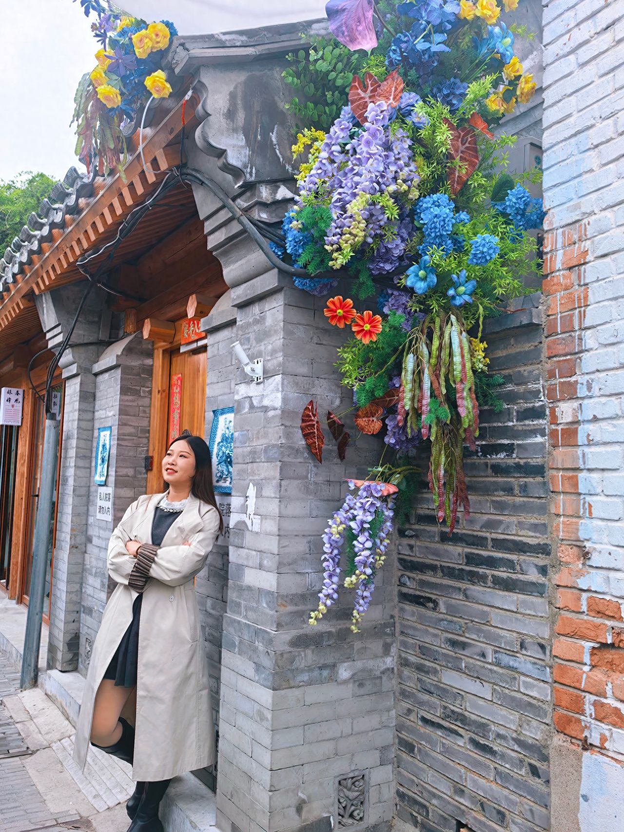 Photo by Romantic Hutong - Take a photo with the decorated flower baskets and brick walls.