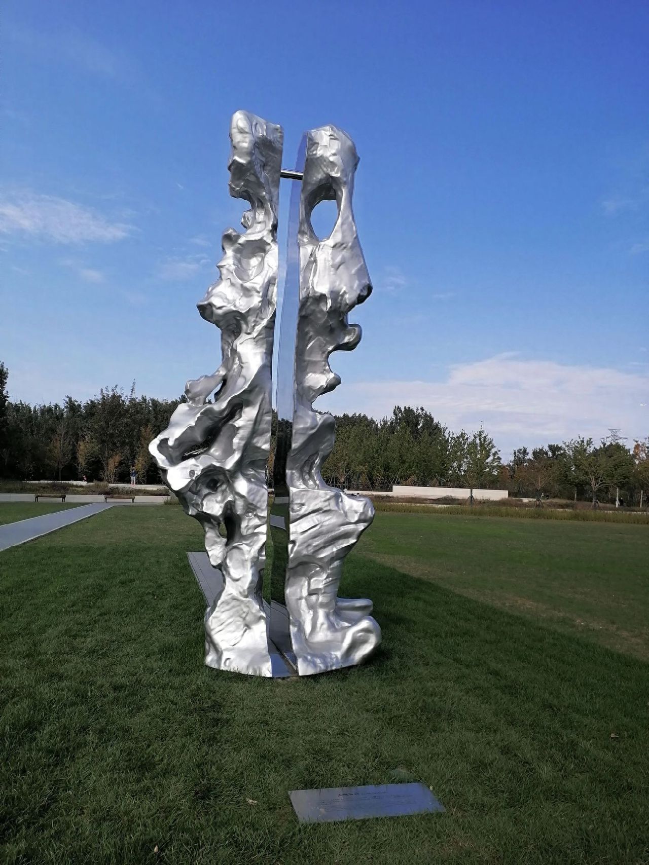 Photo by Beijing Wenyu River Park - Metal Sculpture Dividing the Lawn into Two Halves