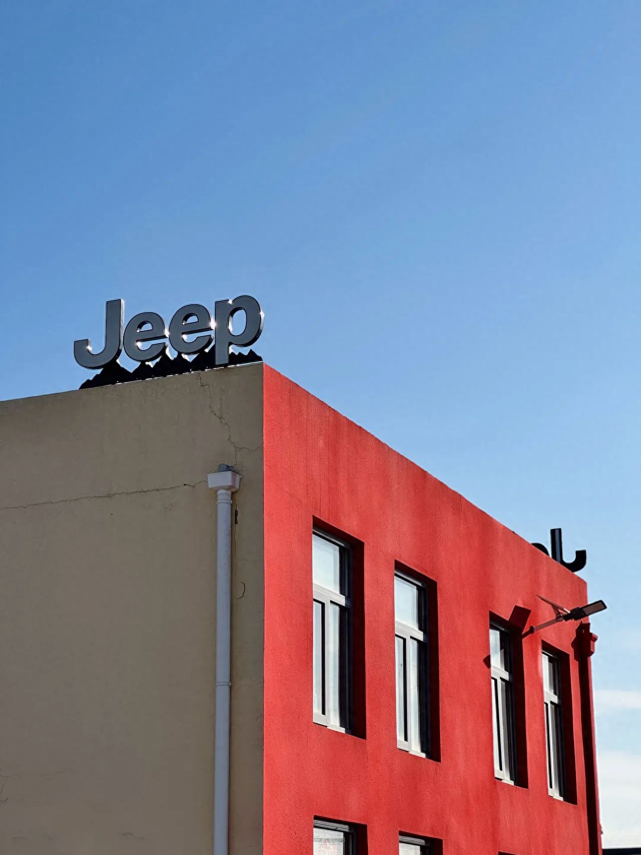 Photo by 491 Space - Red House with Jeep Logo