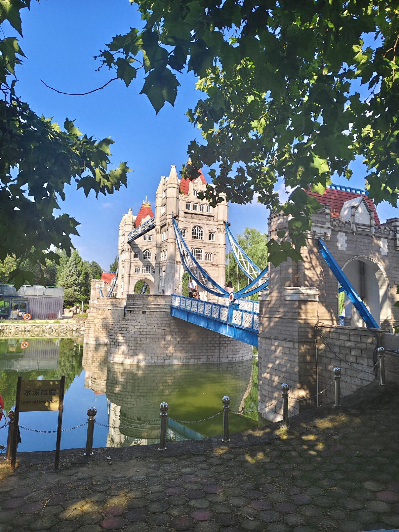 Photo by Beijing World Park - Capturing the bridge architecture and water features through the trees.