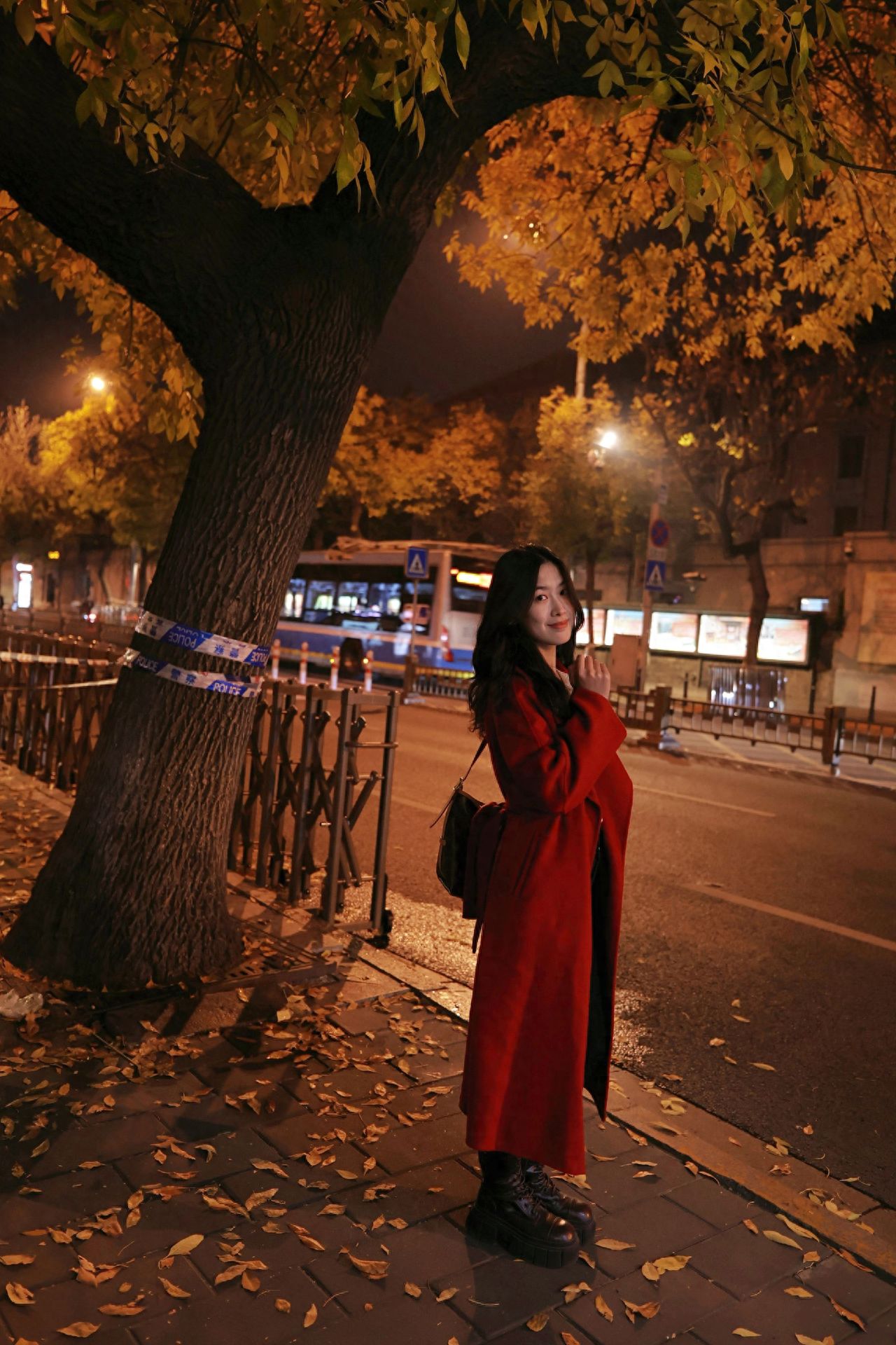 Photo by Take a night photo with autumn leaves and street lamps on Beijing's May 4th Street.