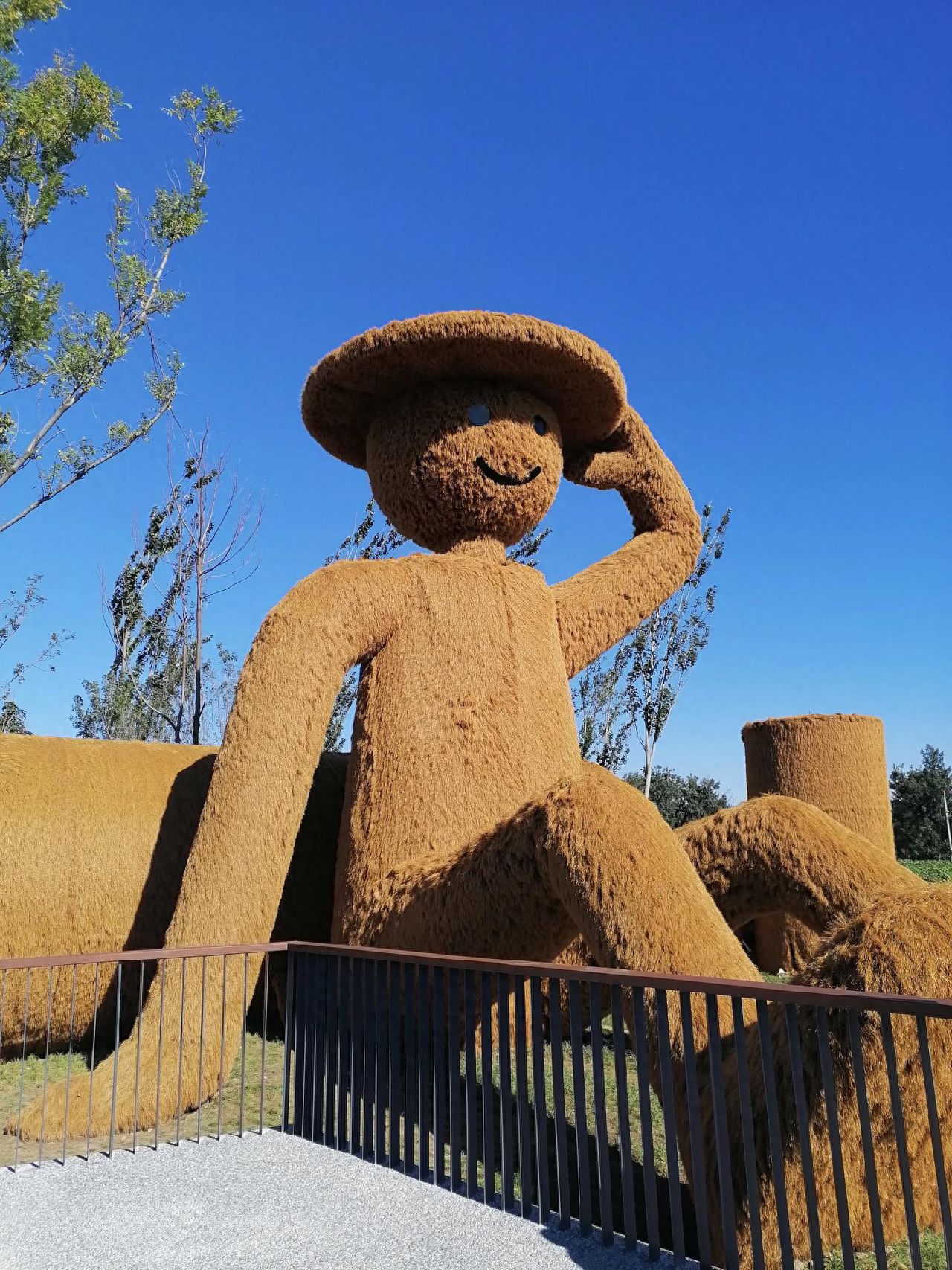 Photo by Wenyu River Park - Taking photos of the scarecrow installation near the railing.