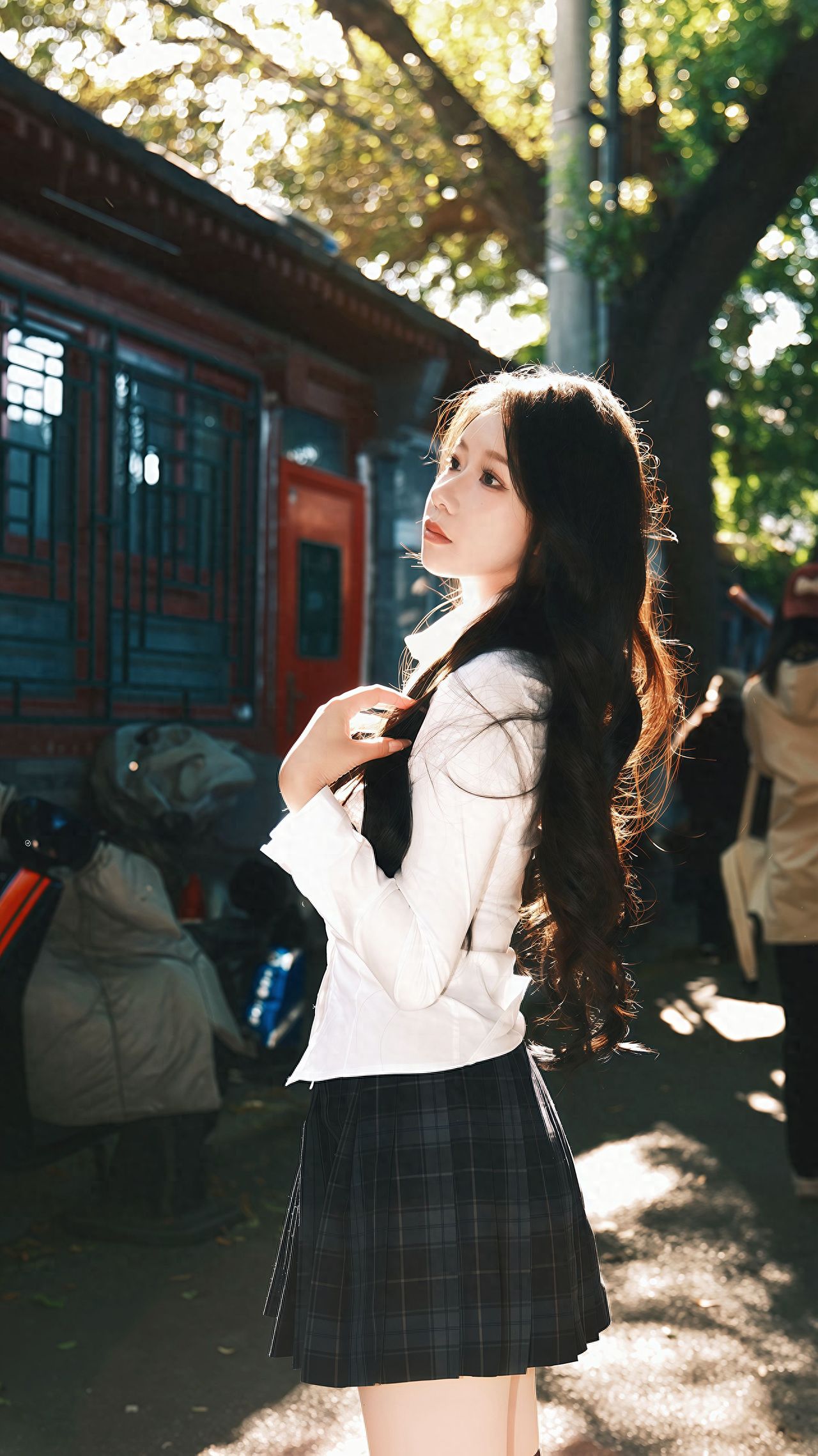 Photo by Beijing May 4th Street - Red brick buildings and autumn green trees in a photo together.