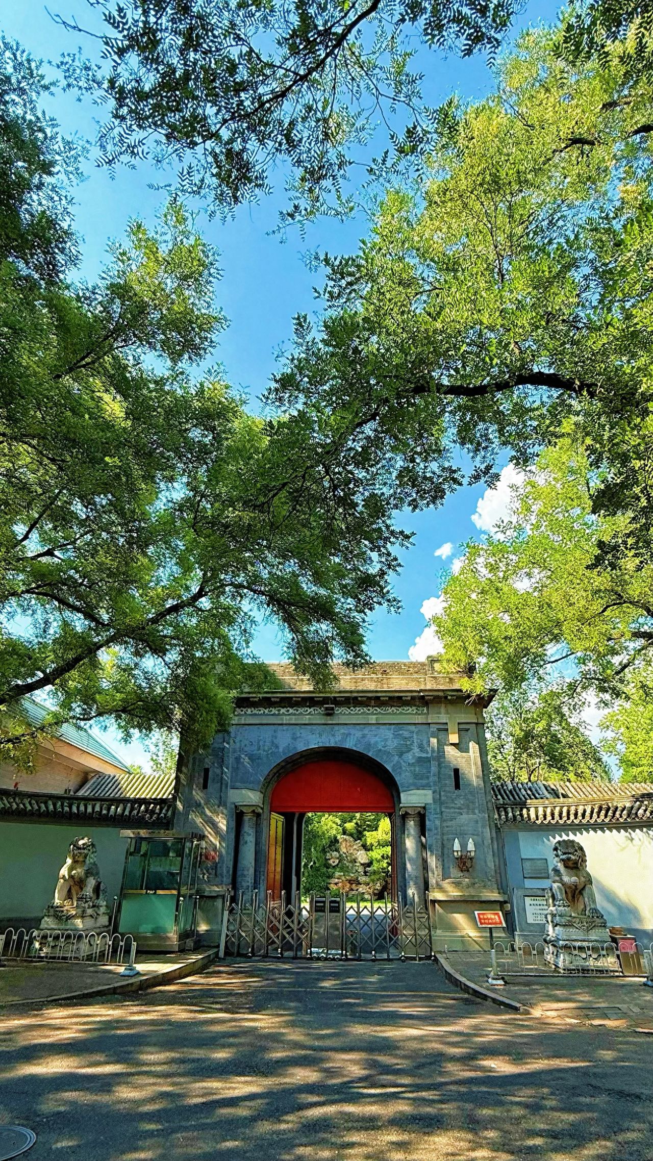 Photo by Dongjiaomin Alley – Chinese Arch Building and Stone Lion Sculpture