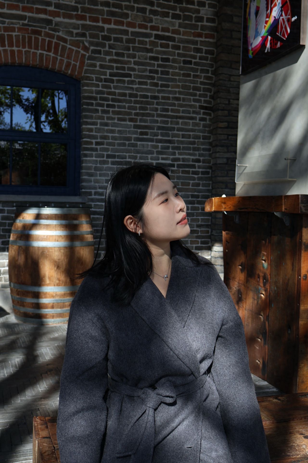 Photo by Beijing May 4th Street - Take a photo with wooden structure seats and brick wall buildings.