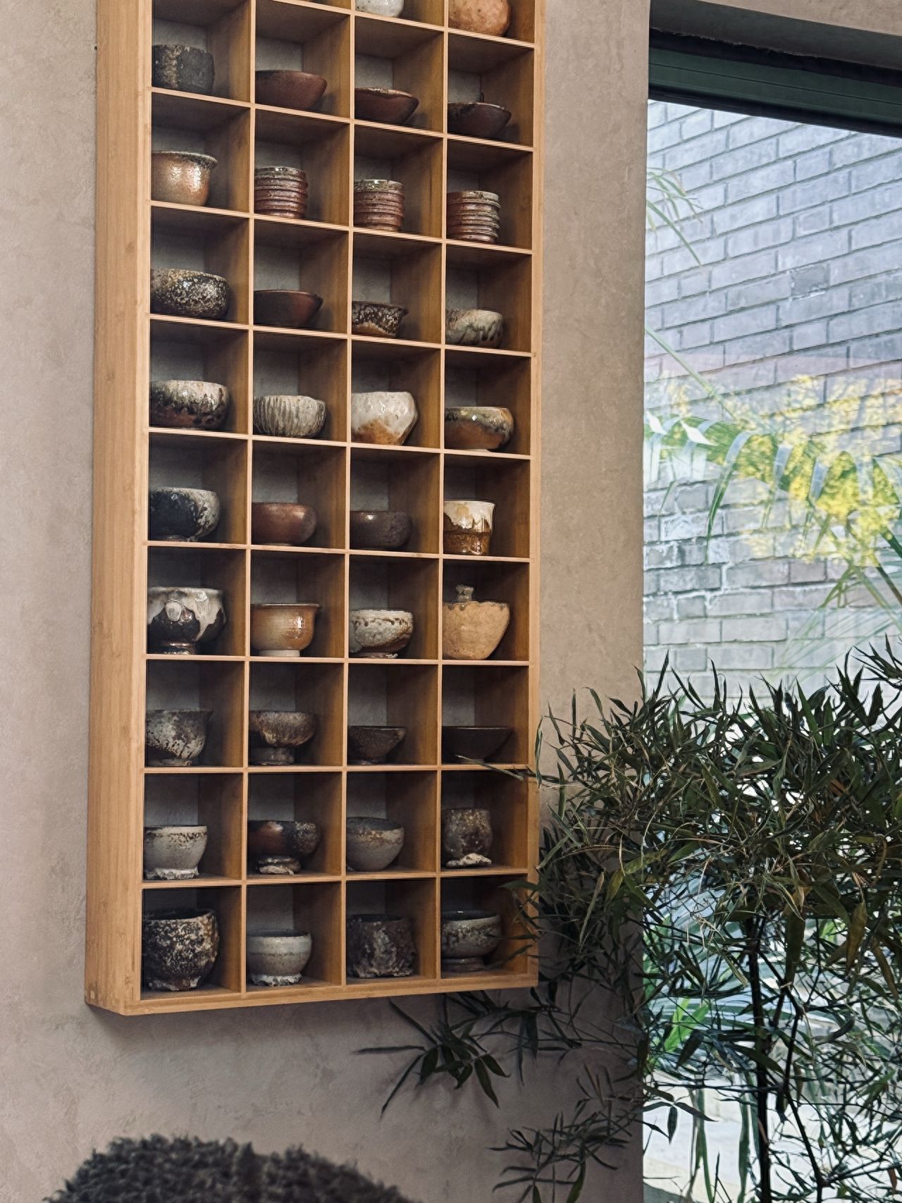 Photo by Lanman Hutong - Ceramic Pot Display Shelves and Green Plants Inside the Store