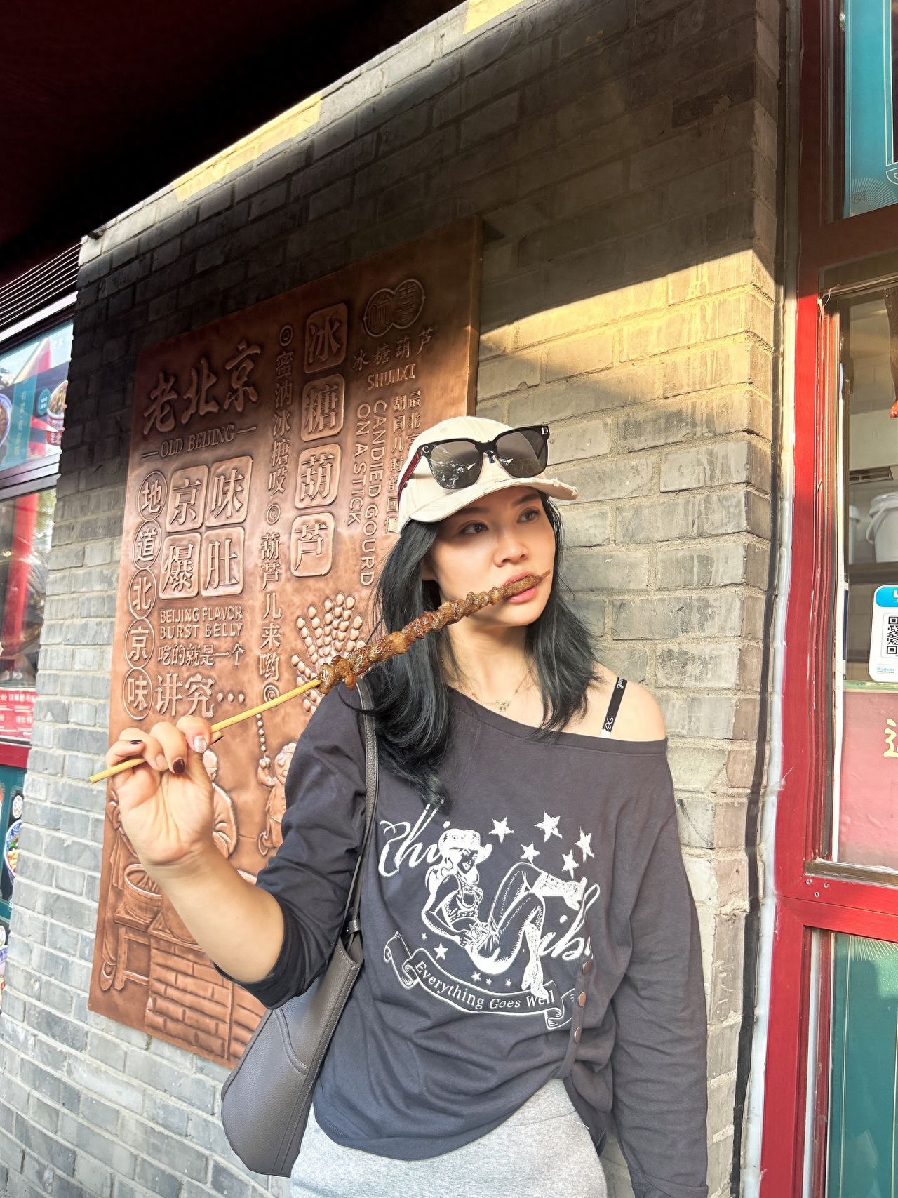 Photo by Nanman Hutong - Take a photo with the brick wall building and the engraved copper plaque.