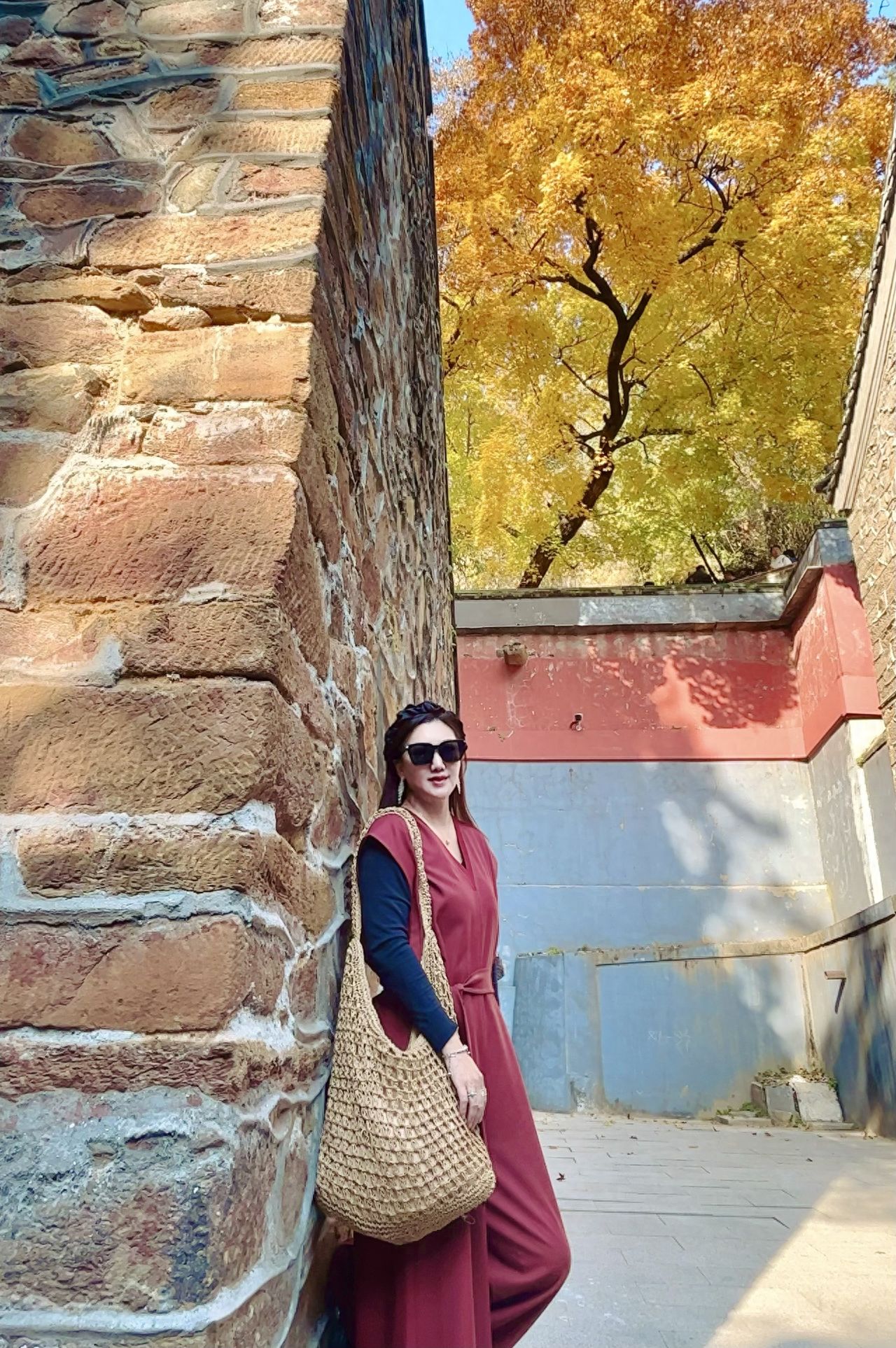 Photo by Tanzhe Temple - Take a photo with the stone walls, red walls, and ginkgo trees.