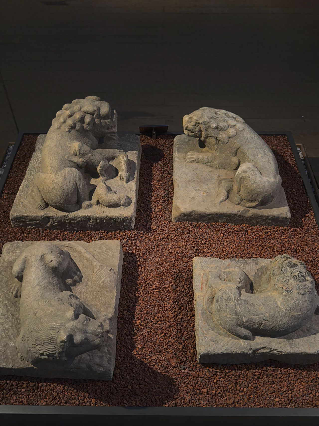 Photo by Beijing Five Pagodas Temple - Four Small Stone Animal Statues on Gravel