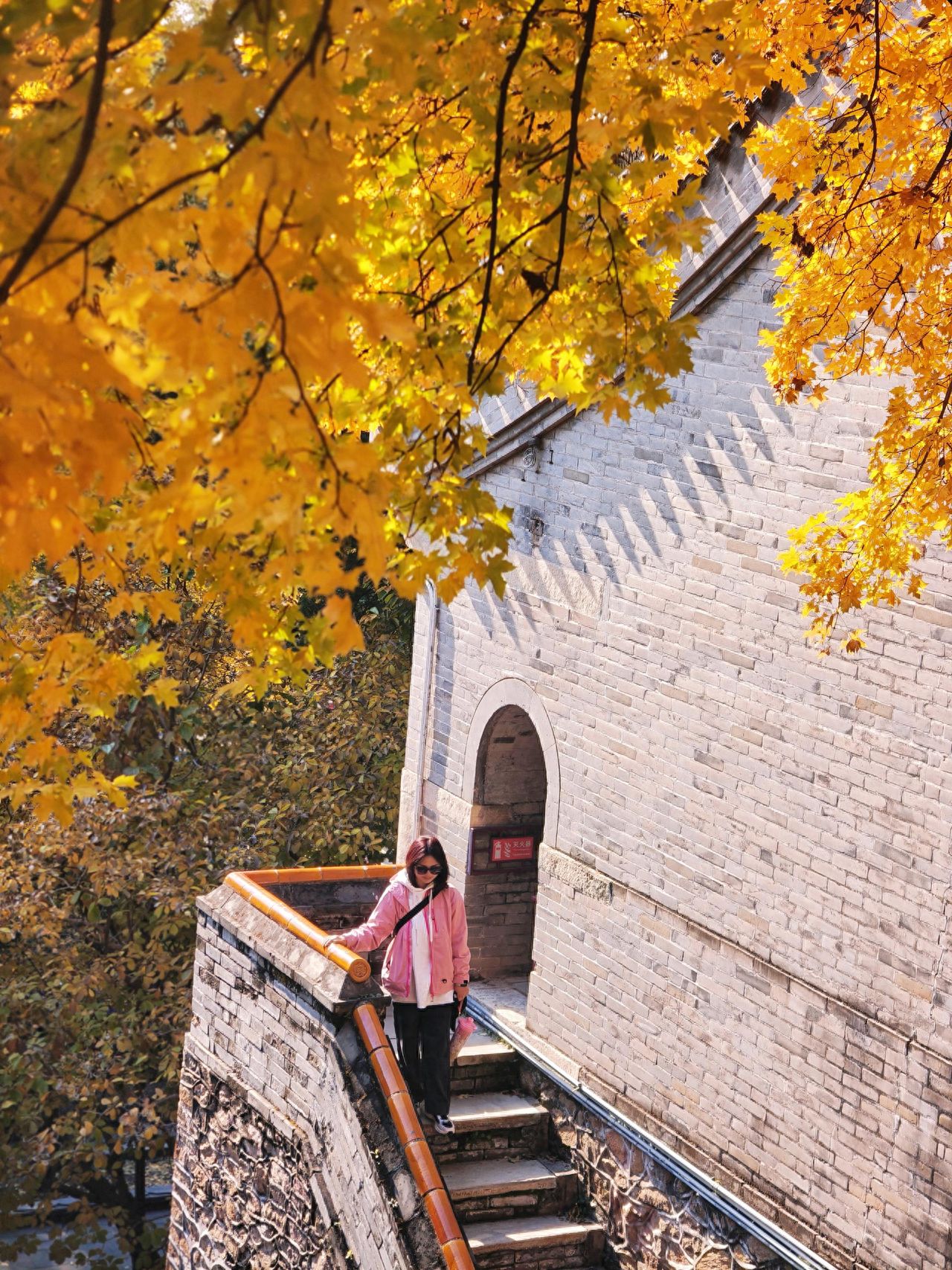 Photo by Take a photo with the brick wall archway and stone steps ginkgo at Tanzhe Temple.