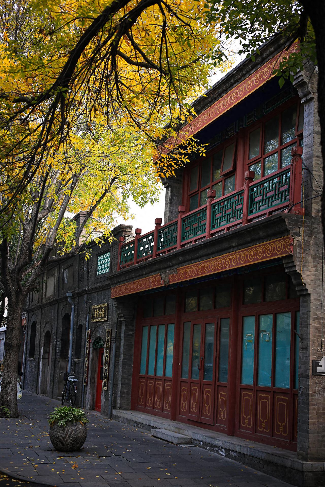 Photo by Xi Xinglong Street - Side view of red buildings and roadside trees