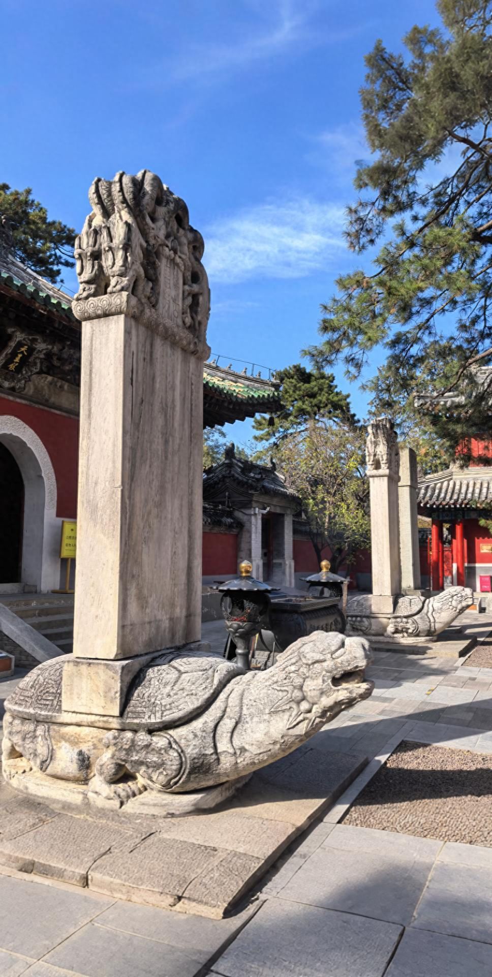 Photo by Tanzhe Temple - Stone Lions, Pillars with Red Walls and Incense Burner in the Same Frame